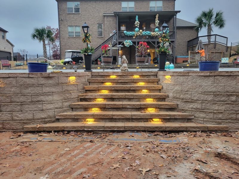 A set of stairs leading up to a house with lights on them.