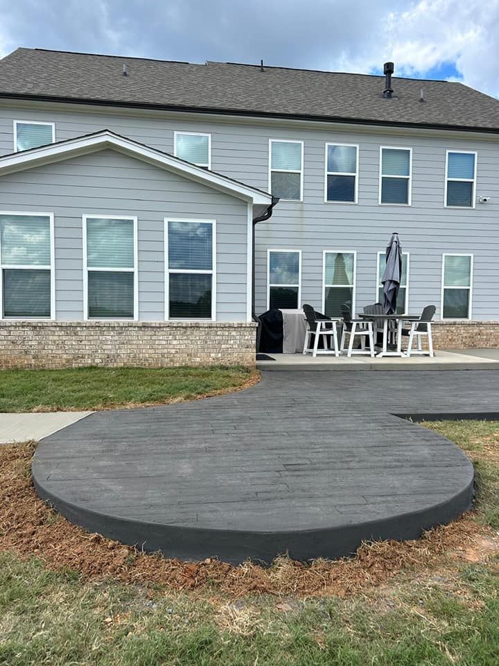 A large house with a circular patio in front of it.