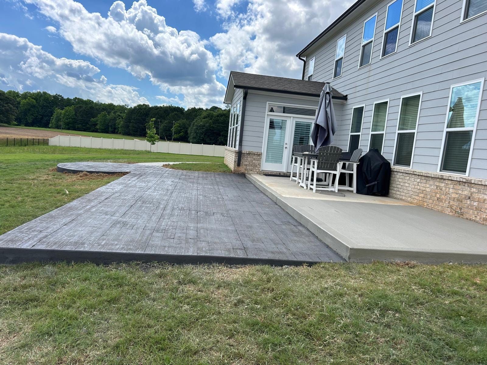 A large house with a large patio in front of it.