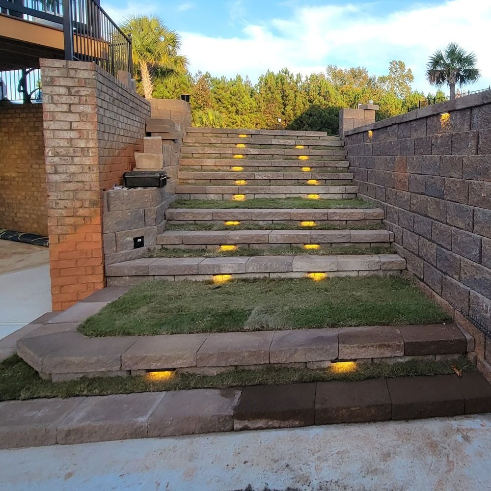 A set of stairs leading up to a brick wall.