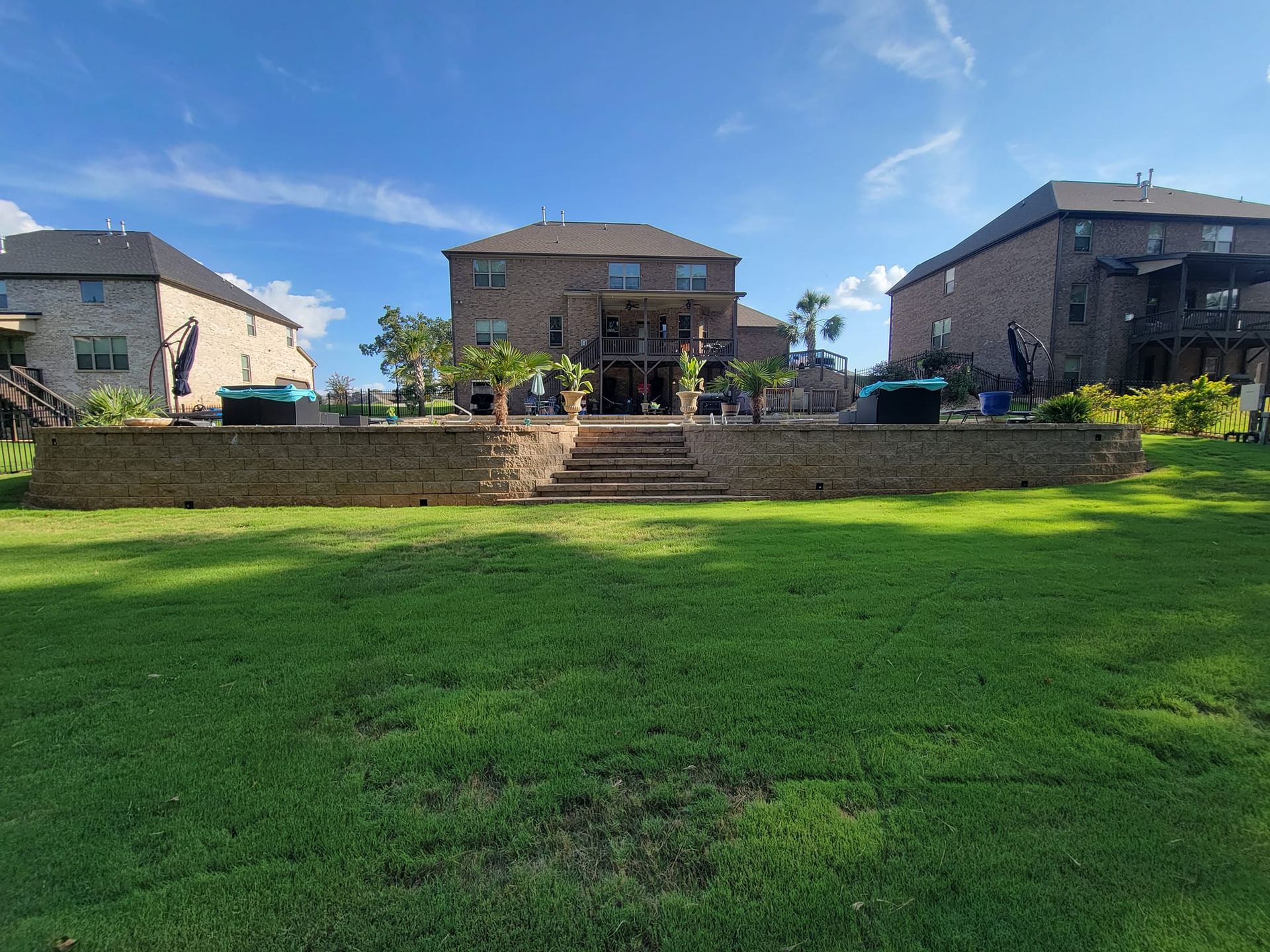 A large house with a large lawn in front of it.