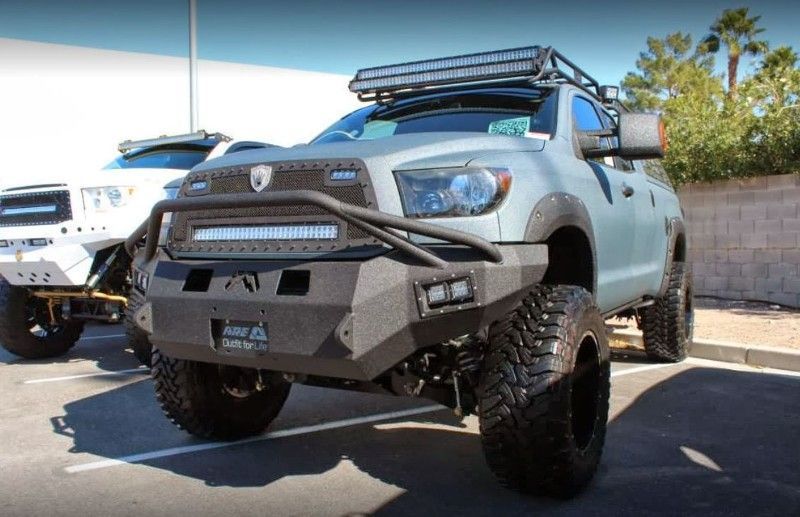 A toyota tundra with a roof rack is parked in a parking lot.