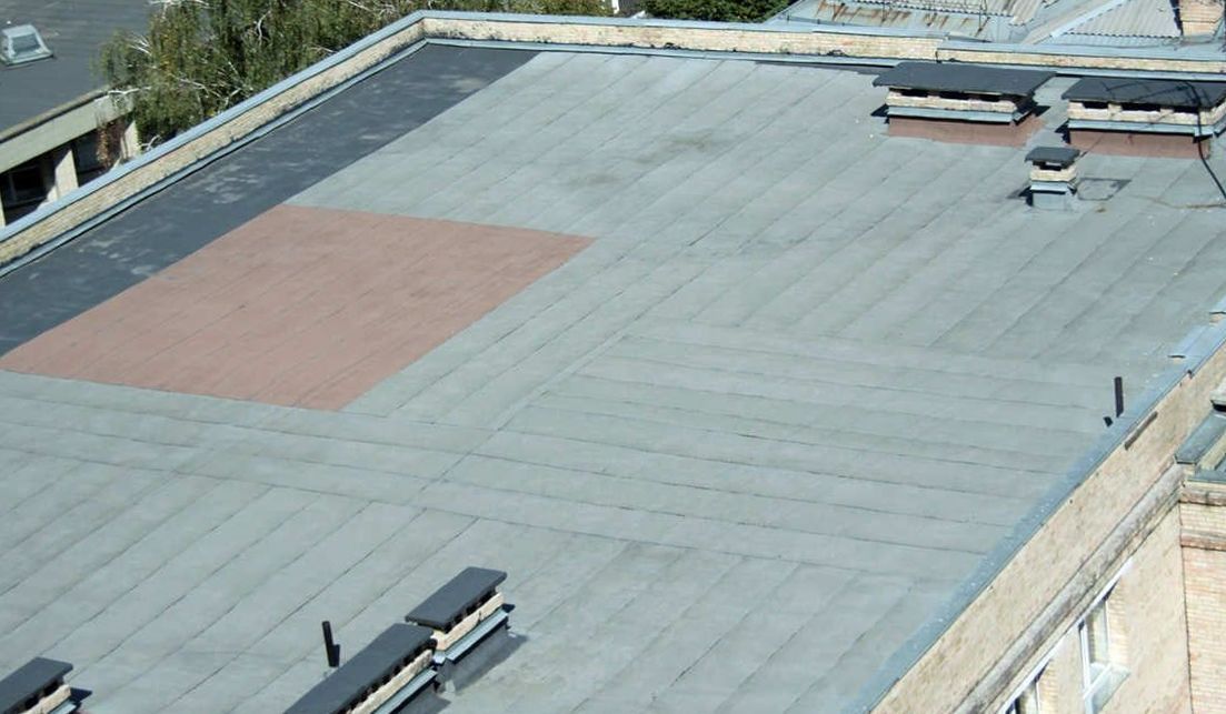 An aerial view of a flat roof of a building