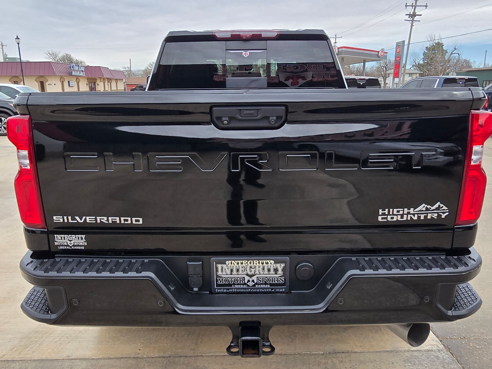 Black Chevrolet Silverado pickup truck with “Chevrolet” and “Silverado High Country” markings.