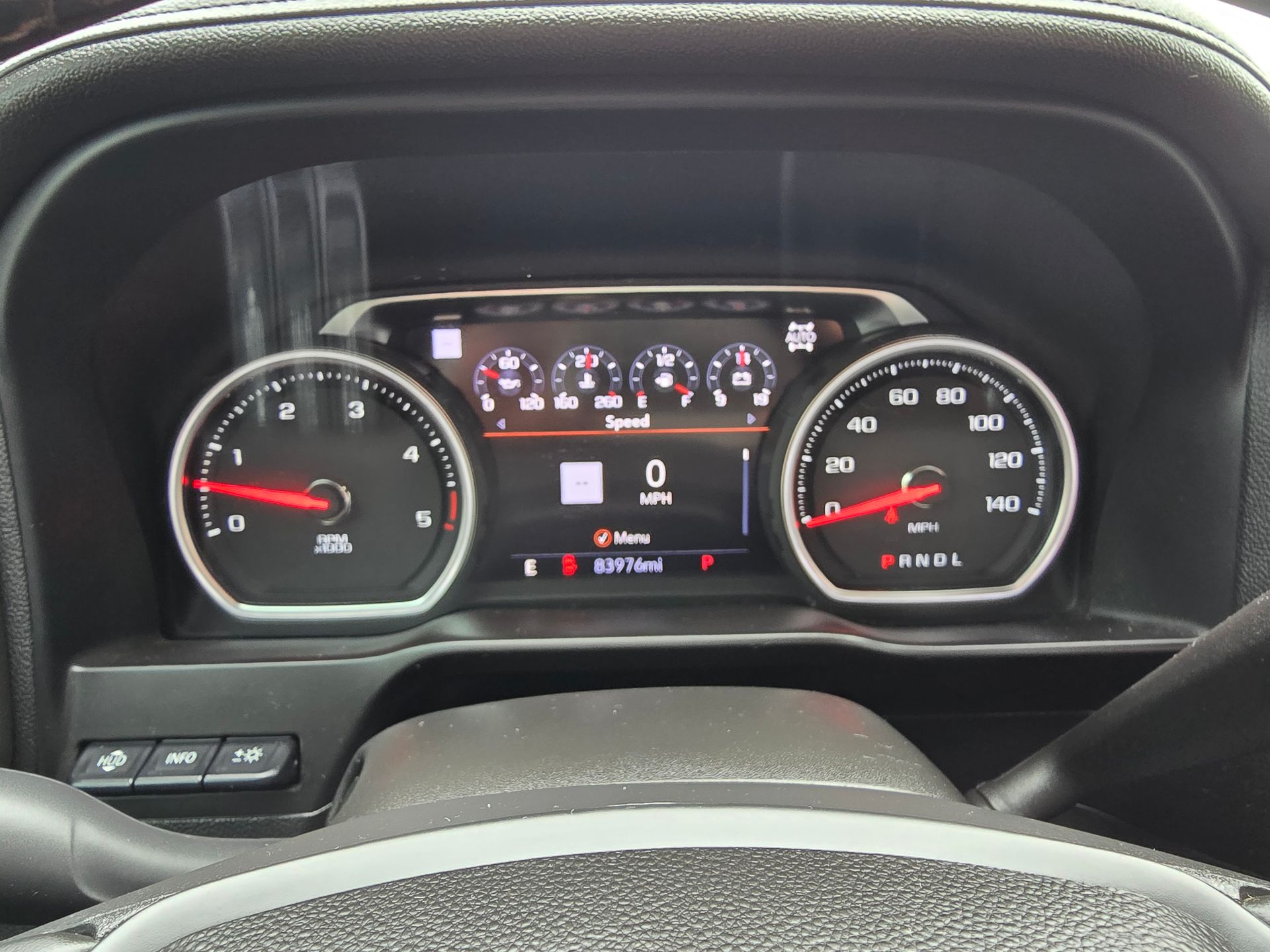 Dashboard of a vehicle showing gauges for speed, fuel, and engine status, with a central information display.