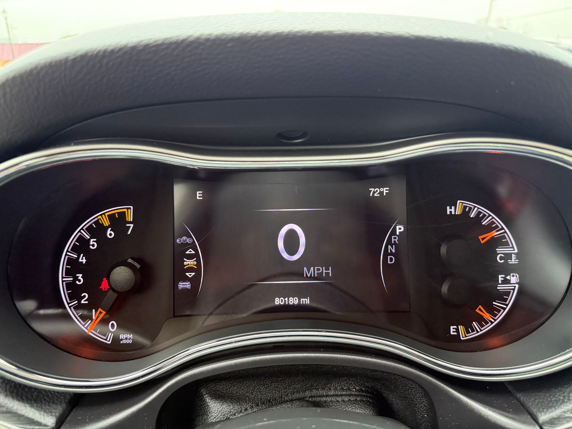 Dashboard of a car showing the speedometer at 0 MPH and the engine rpm gauge.