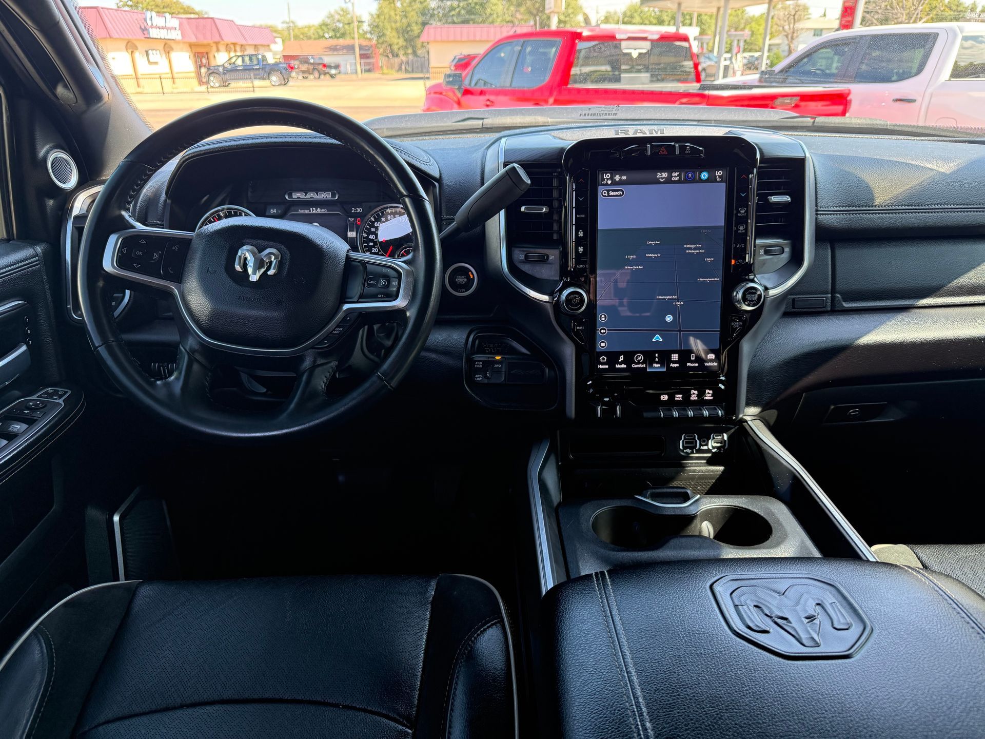 Interior of a Ram truck, showing the dashboard, steering wheel, and large touchscreen display.