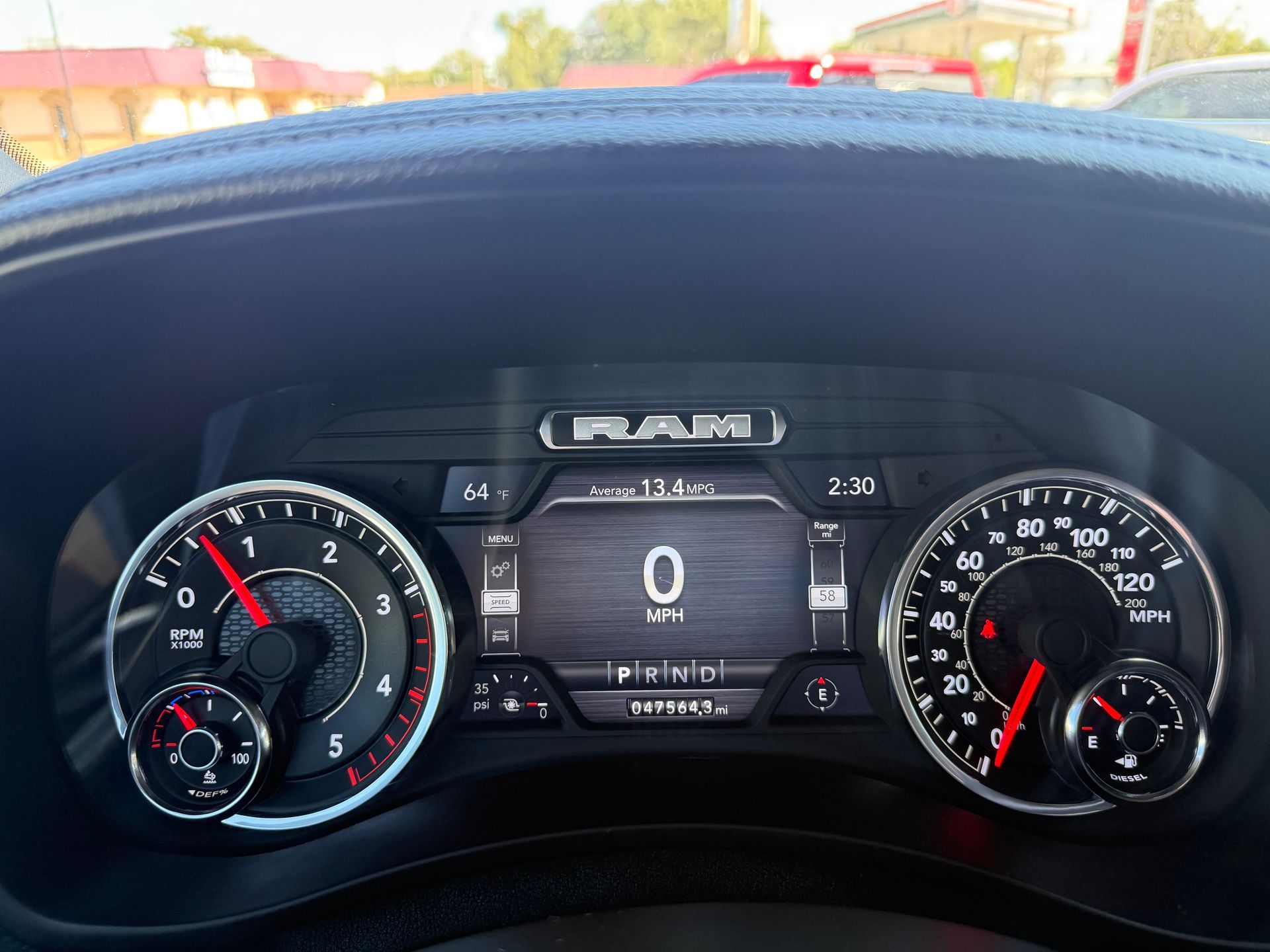Dashboard of a RAM truck, showing speedometer at 0 mph and tachometer near 1, with illuminated displays.