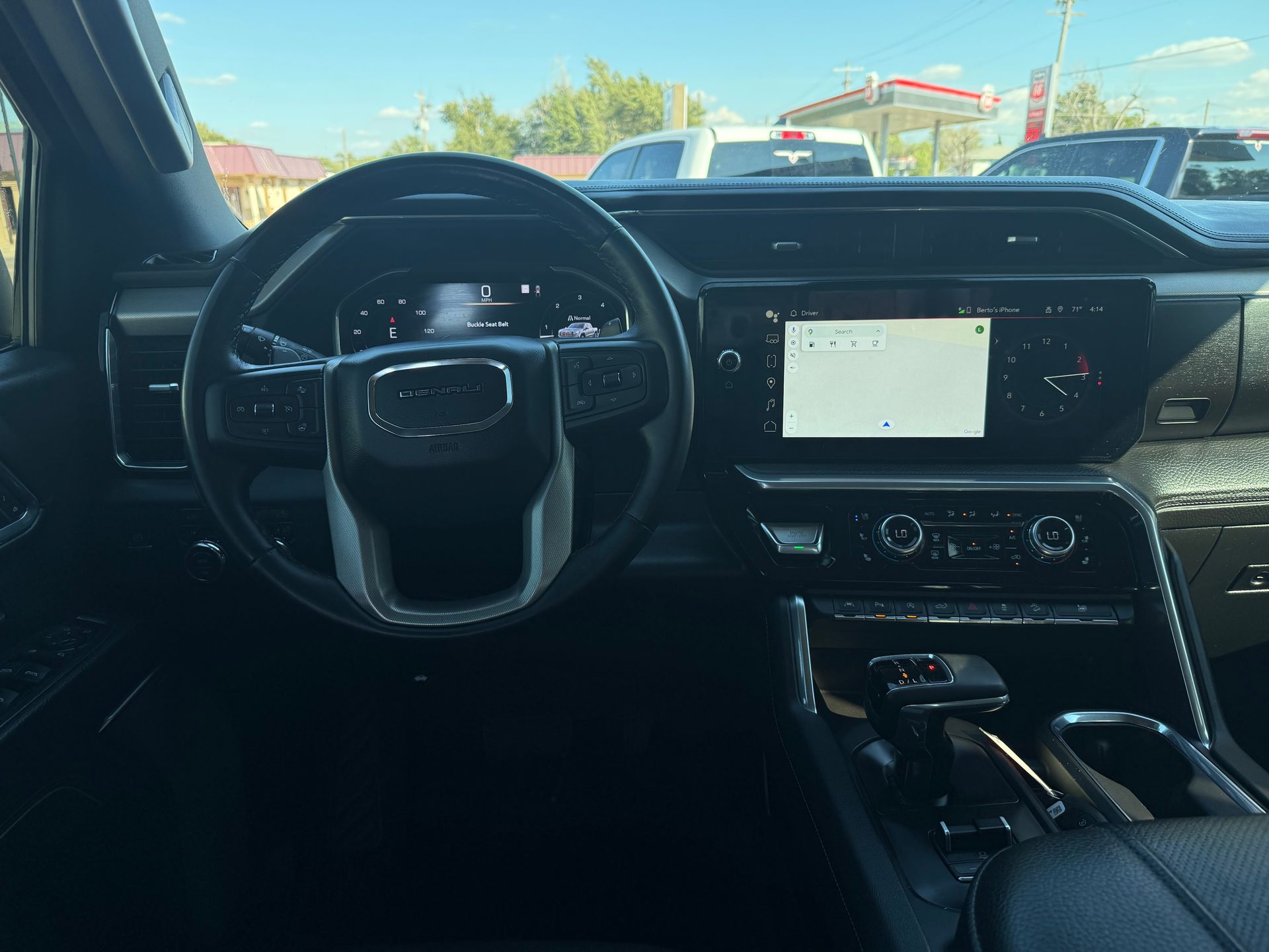 Interior view of a black GMC Sierra truck dashboard. 