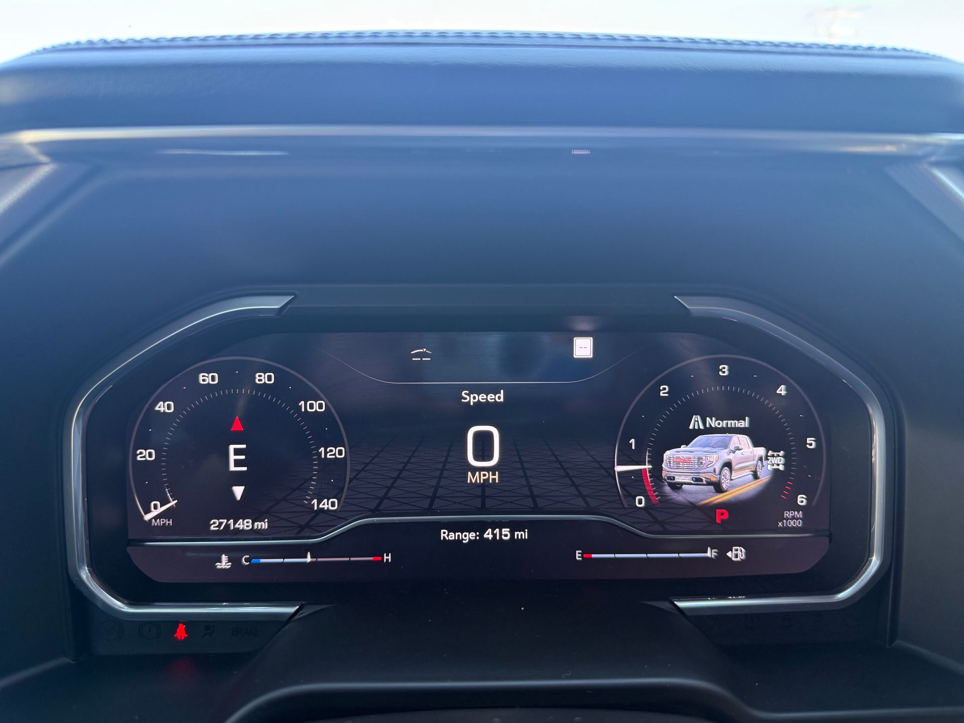 Dashboard of a vehicle showing speed, gauges, and a truck graphic.