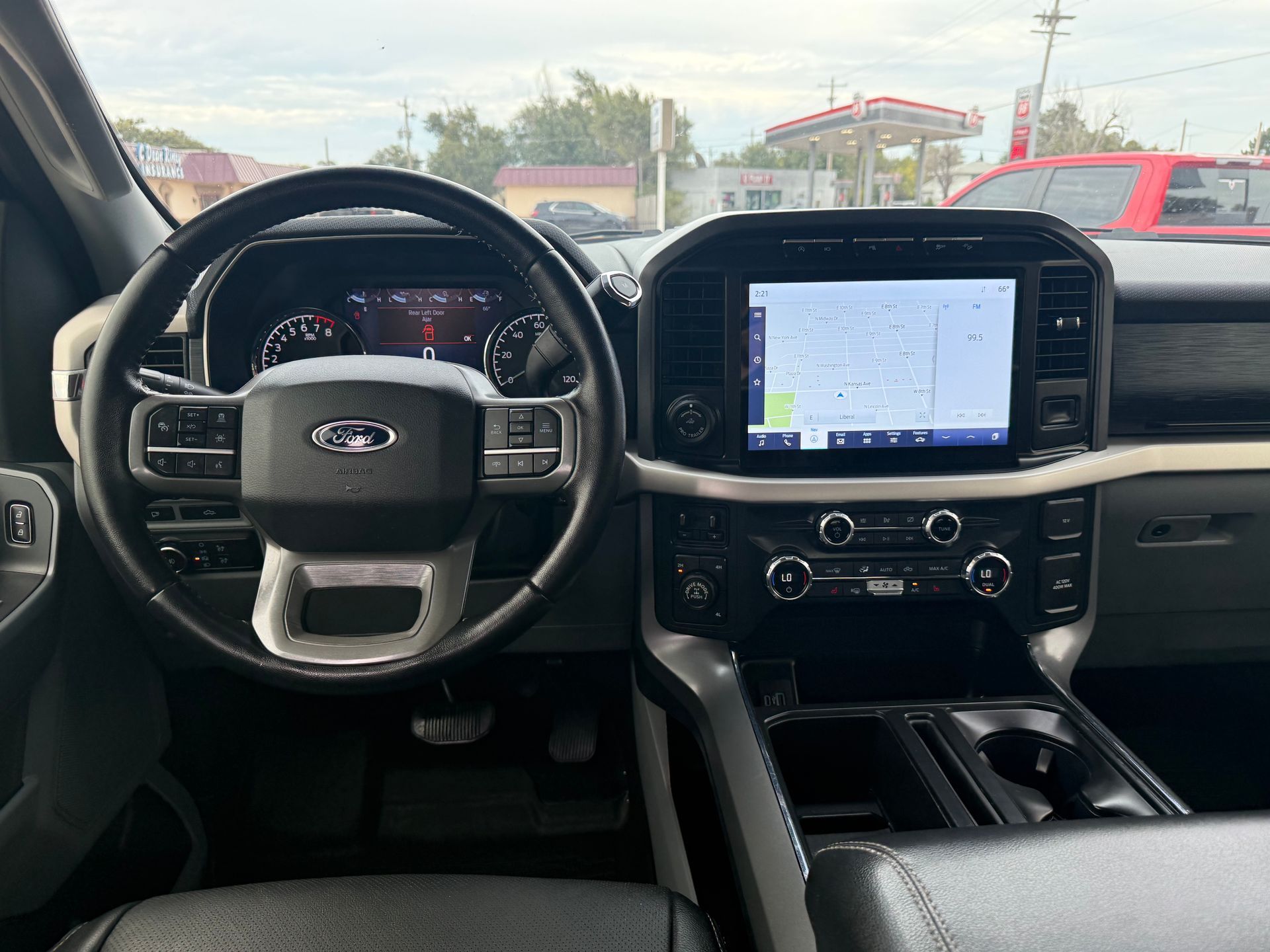 Ford F-150 truck interior. Dashboard features large touchscreen, steering wheel with controls, and center console.