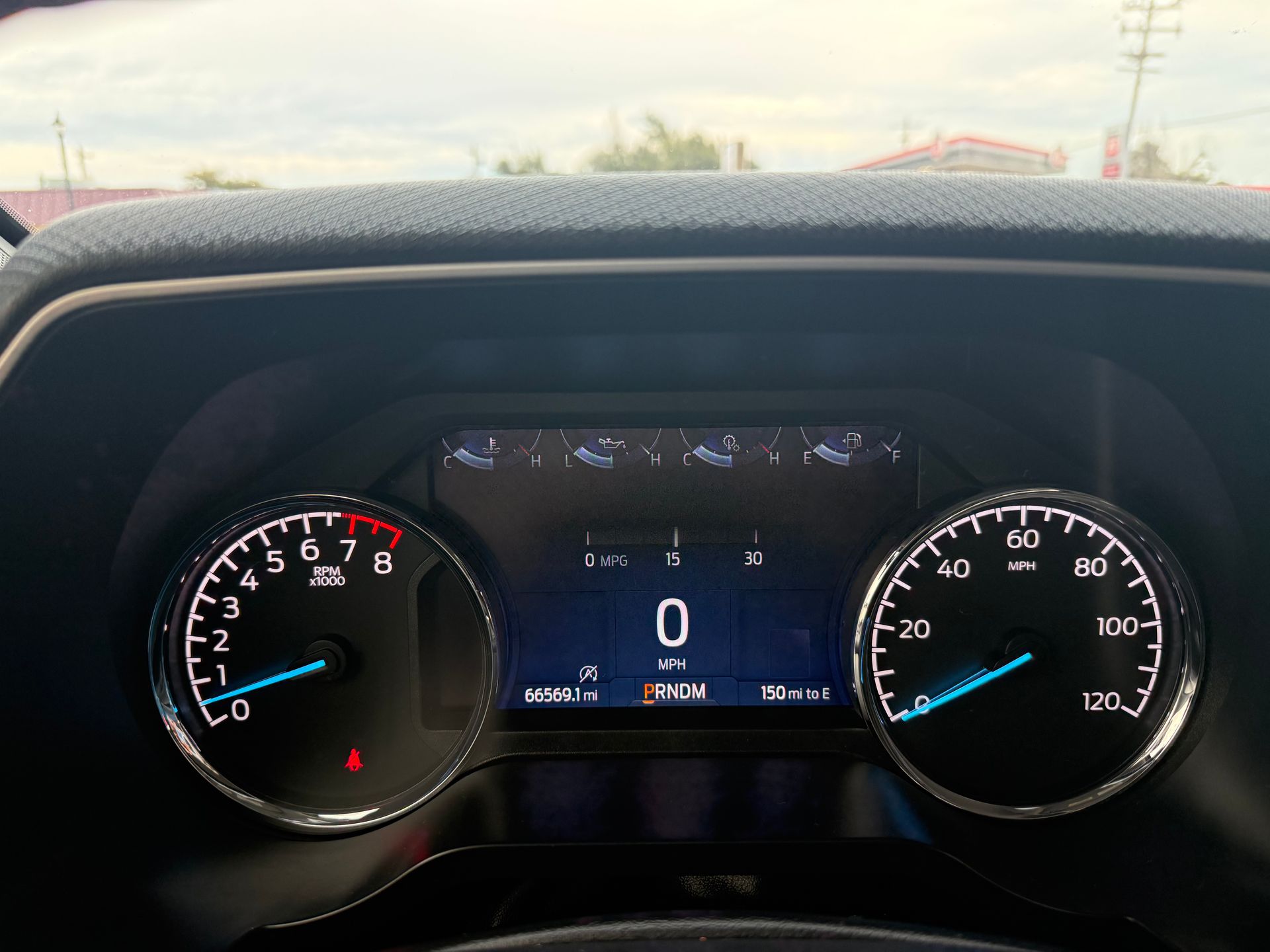 Dashboard of a Ford truck, showing speedometer, tachometer, and digital display.
