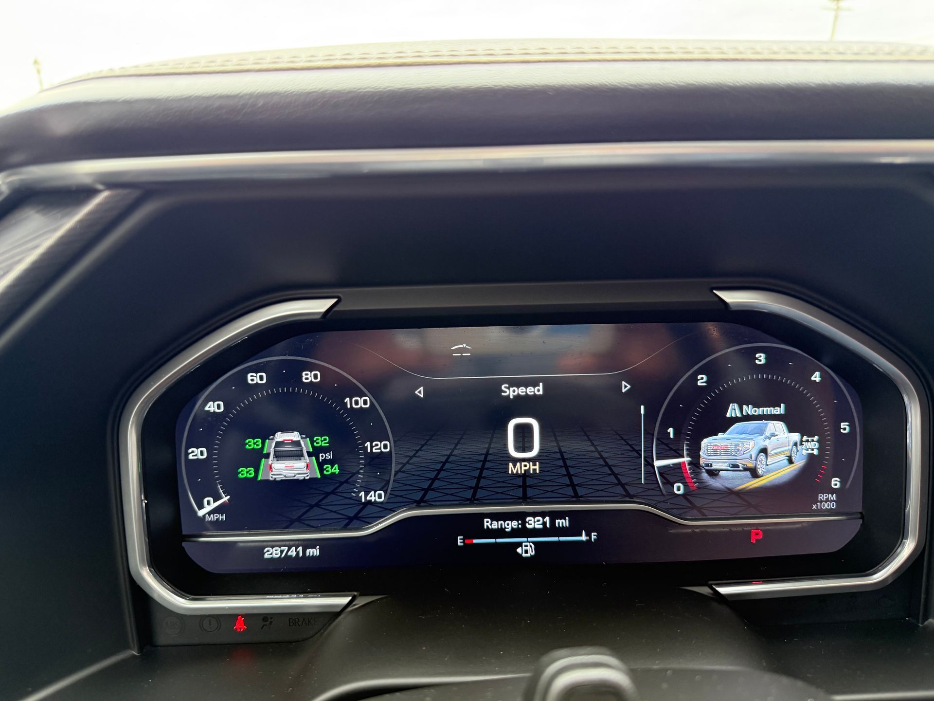 Digital vehicle dashboard displaying speed, range, and vehicle status with green and white icons.