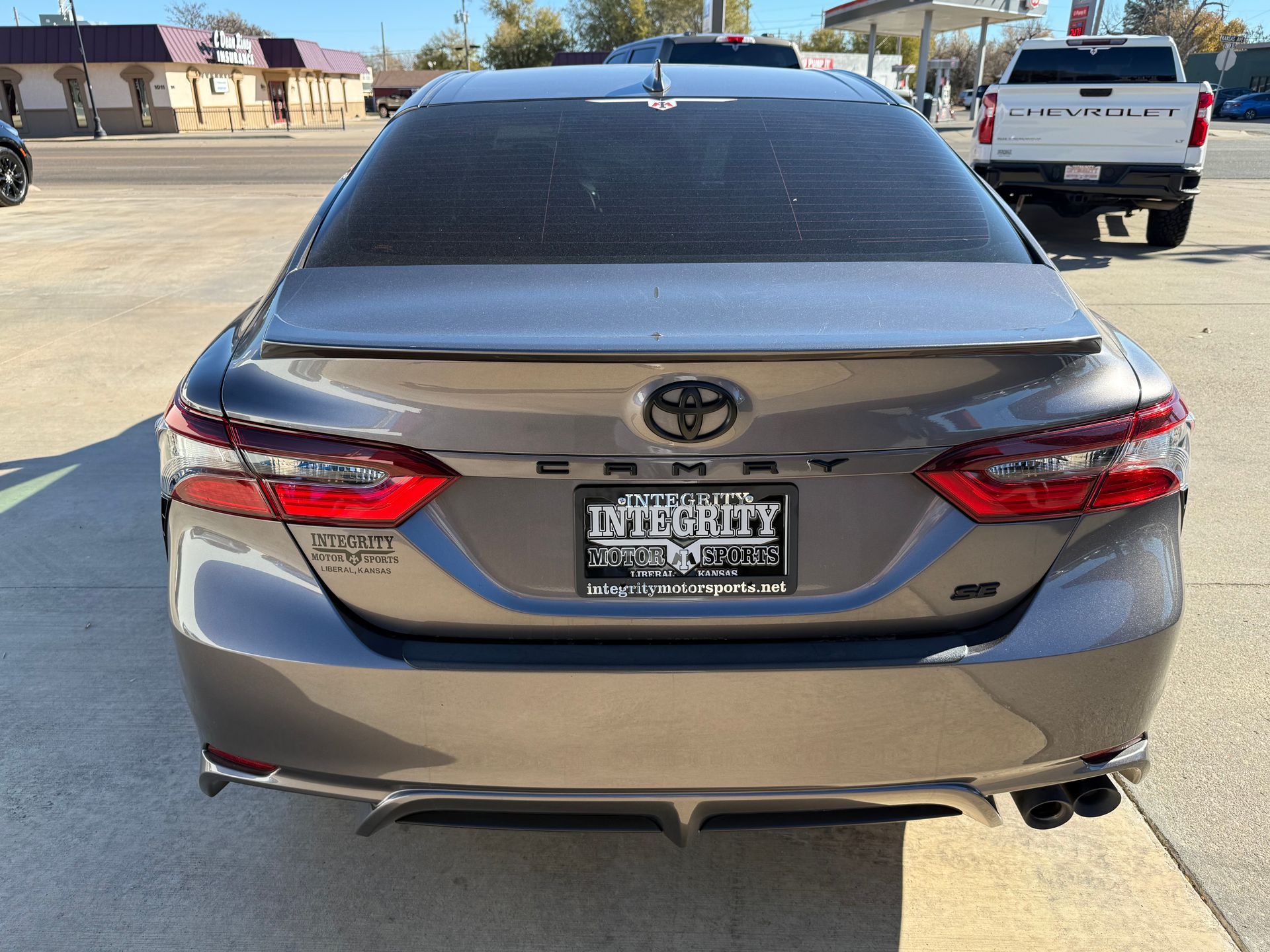 Rear view of a gray Toyota Camry sedan with tinted windows, parked outdoors.