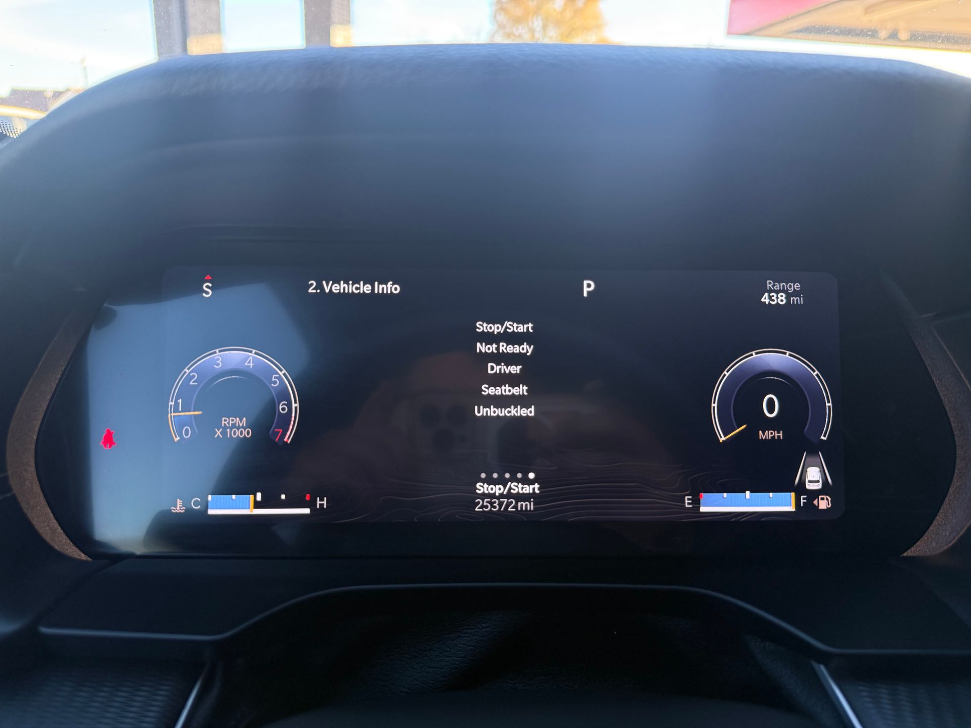 Dashboard display showing vehicle information, including speed, gear, and warnings.