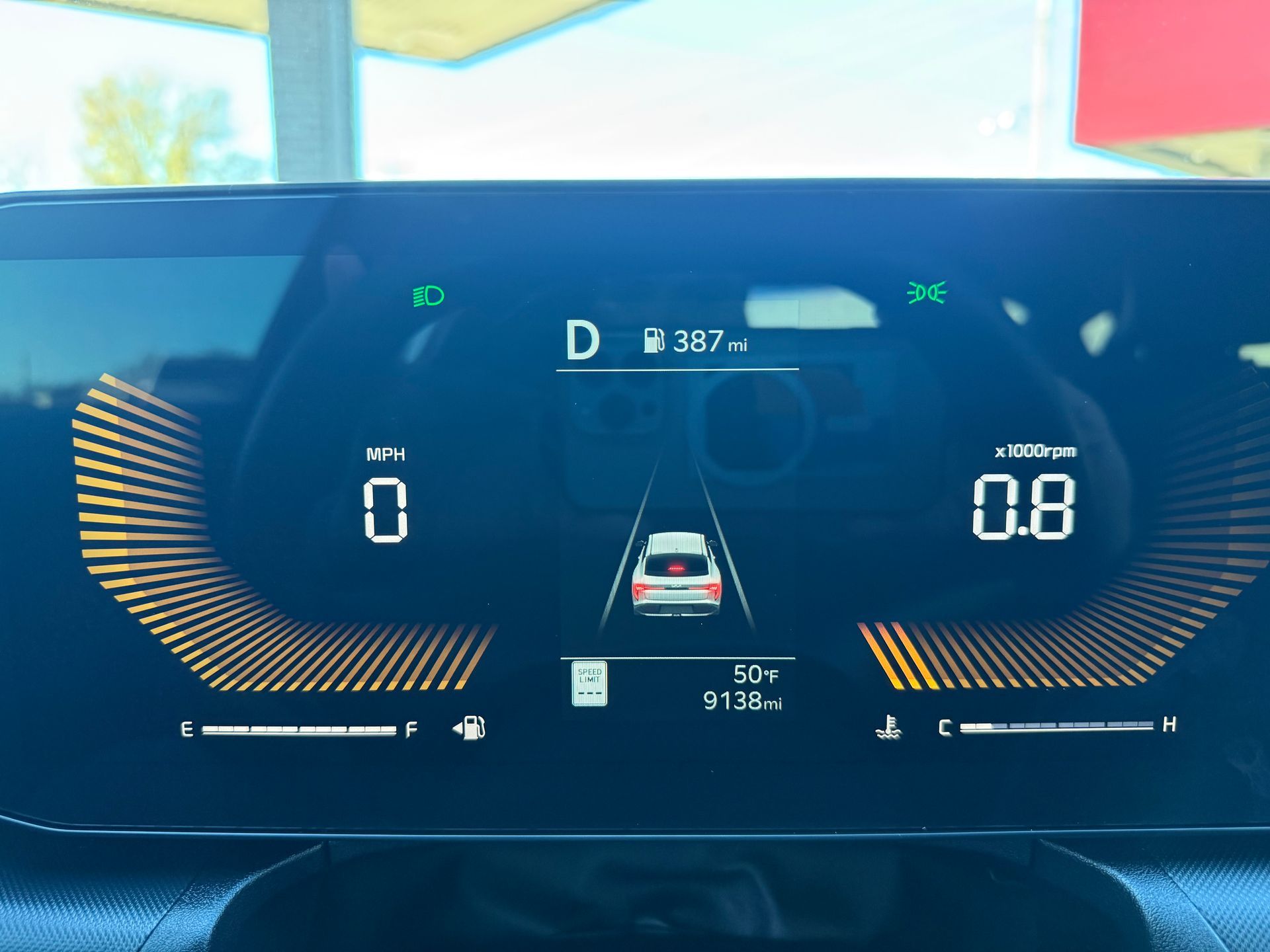 Car dashboard displaying speed 0 MPH, gear D, and engine RPM 0.8. Shows distance traveled and other car data.