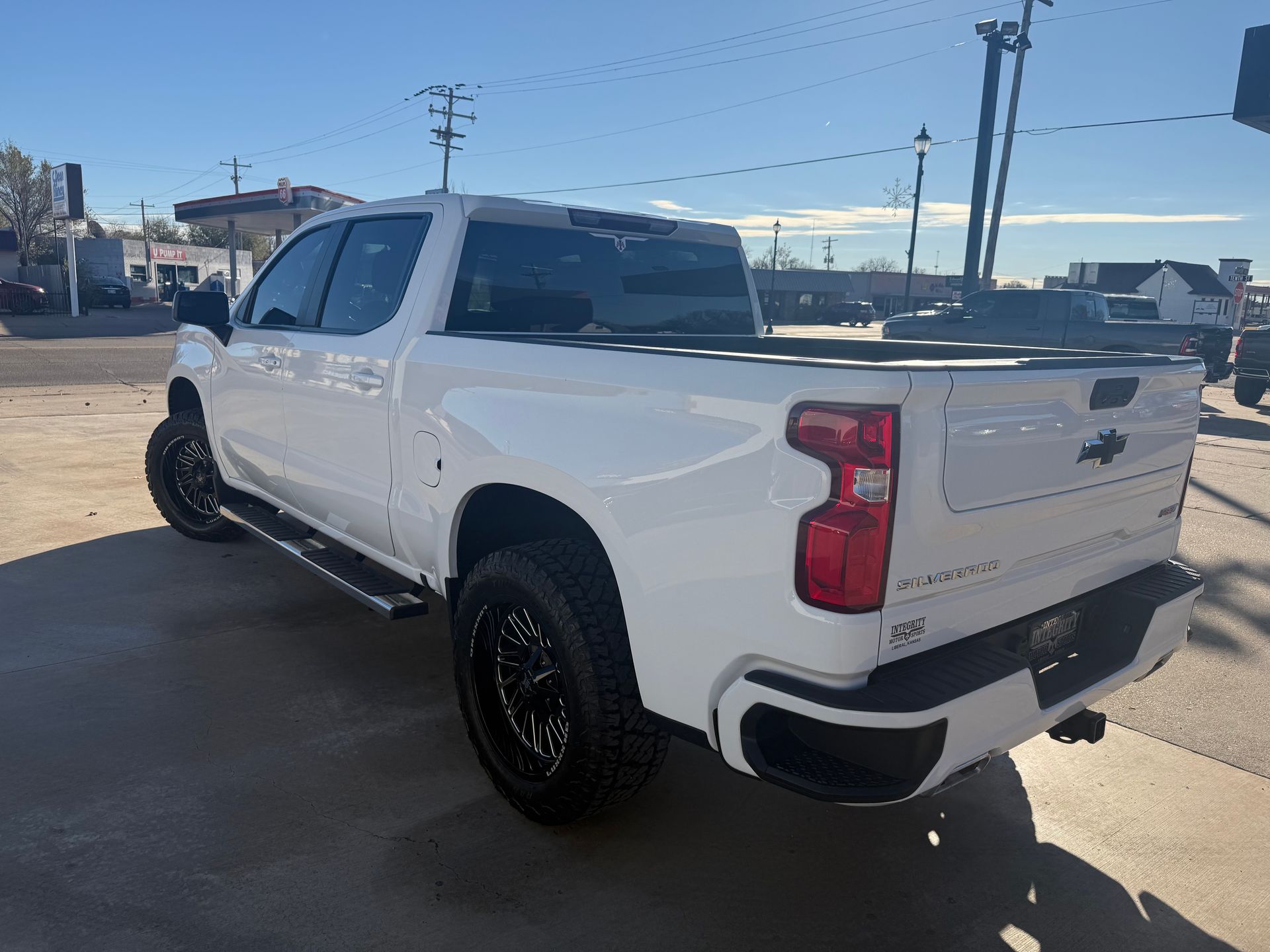 White Chevy Silverado truck parked on a sunny day.