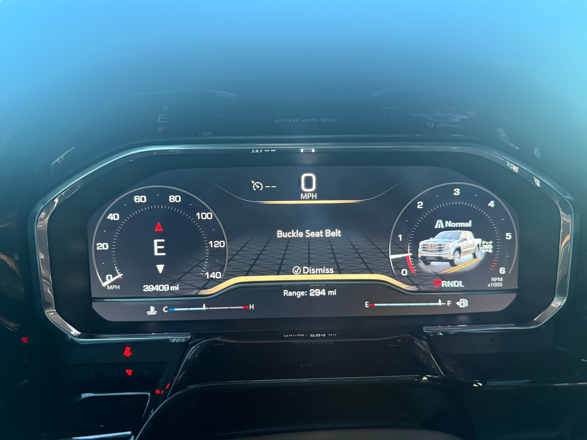 Dashboard of a vehicle, showing speedometer, gear, vehicle information, and range.
