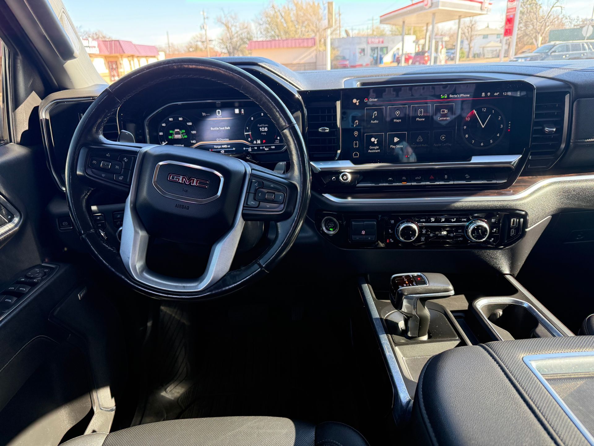 Black GMC truck interior with steering wheel, dashboard, and console.