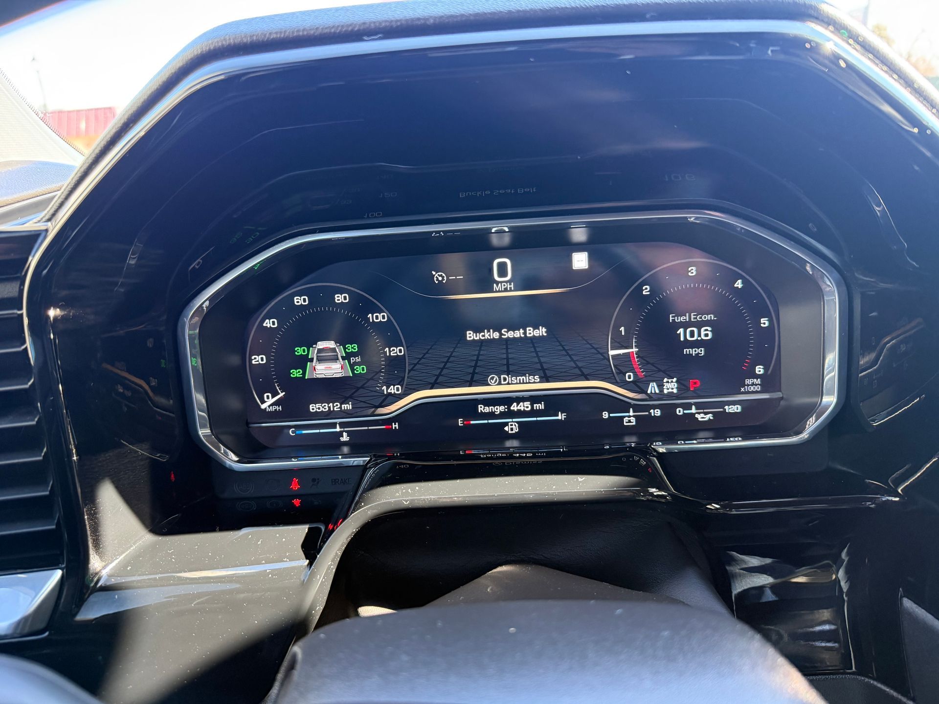 Dashboard of a car showing digital displays with information on speed and vehicle status.