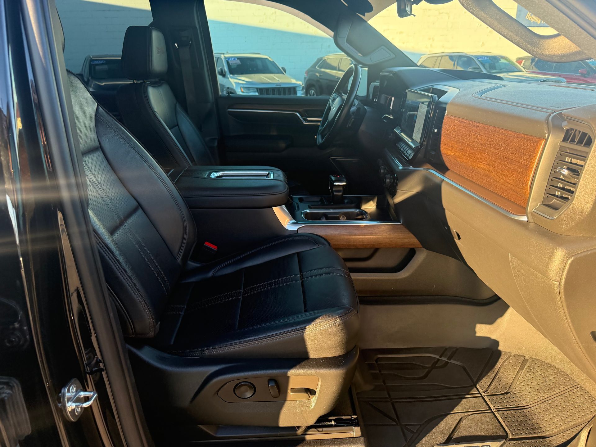 Black leather interior of a truck, featuring a front seat, center console, and dashboard.