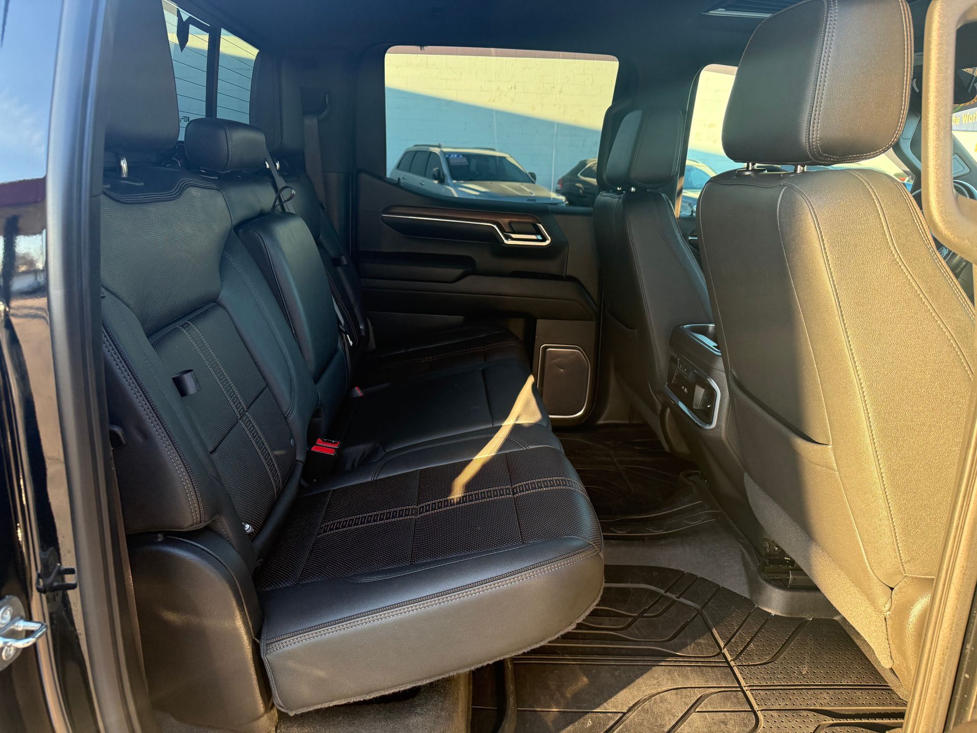 Black leather truck seats; rear cabin view.