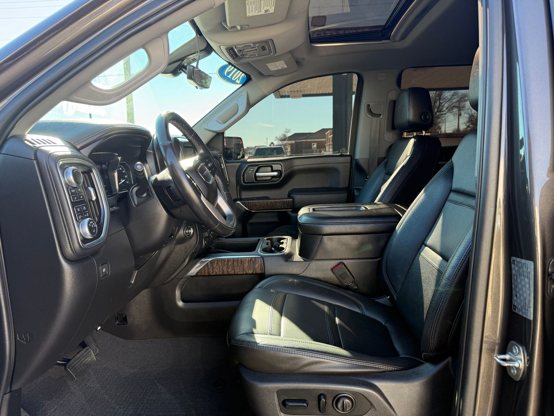 Black truck interior with black leather seats, steering wheel, and console.