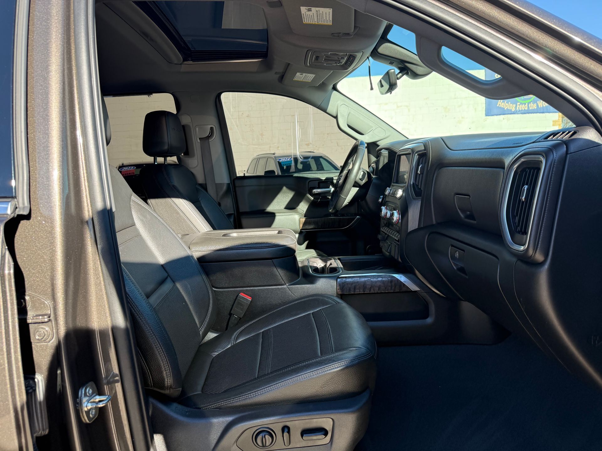 Interior of a pickup truck with black leather seats, a sunroof, and a detailed dashboard.