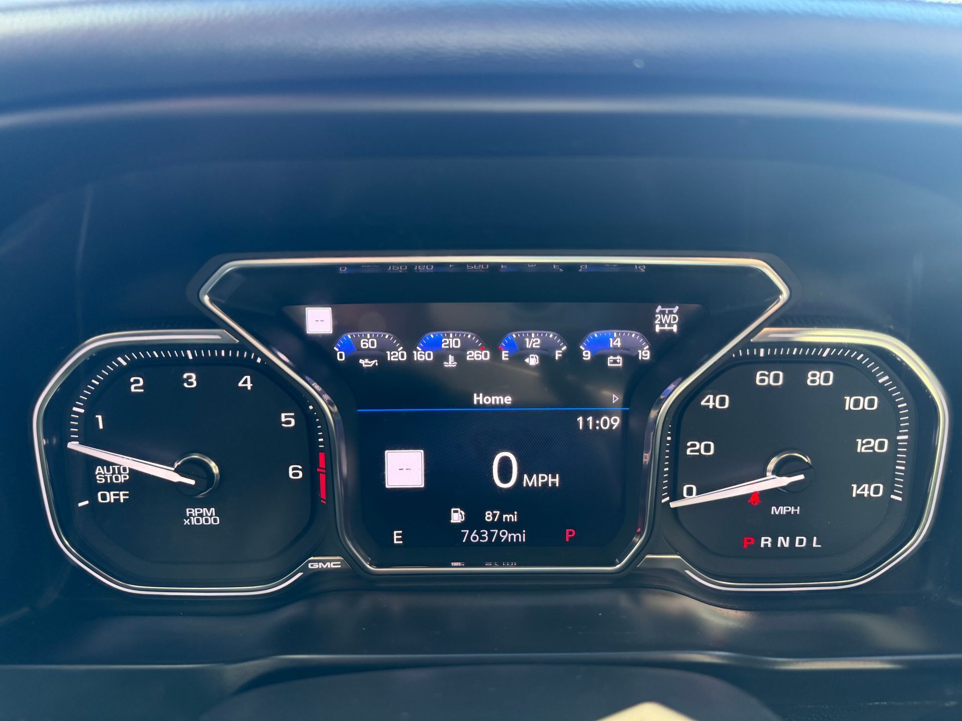 Dashboard of a vehicle showing gauges and informational displays, including speed and fuel level.
