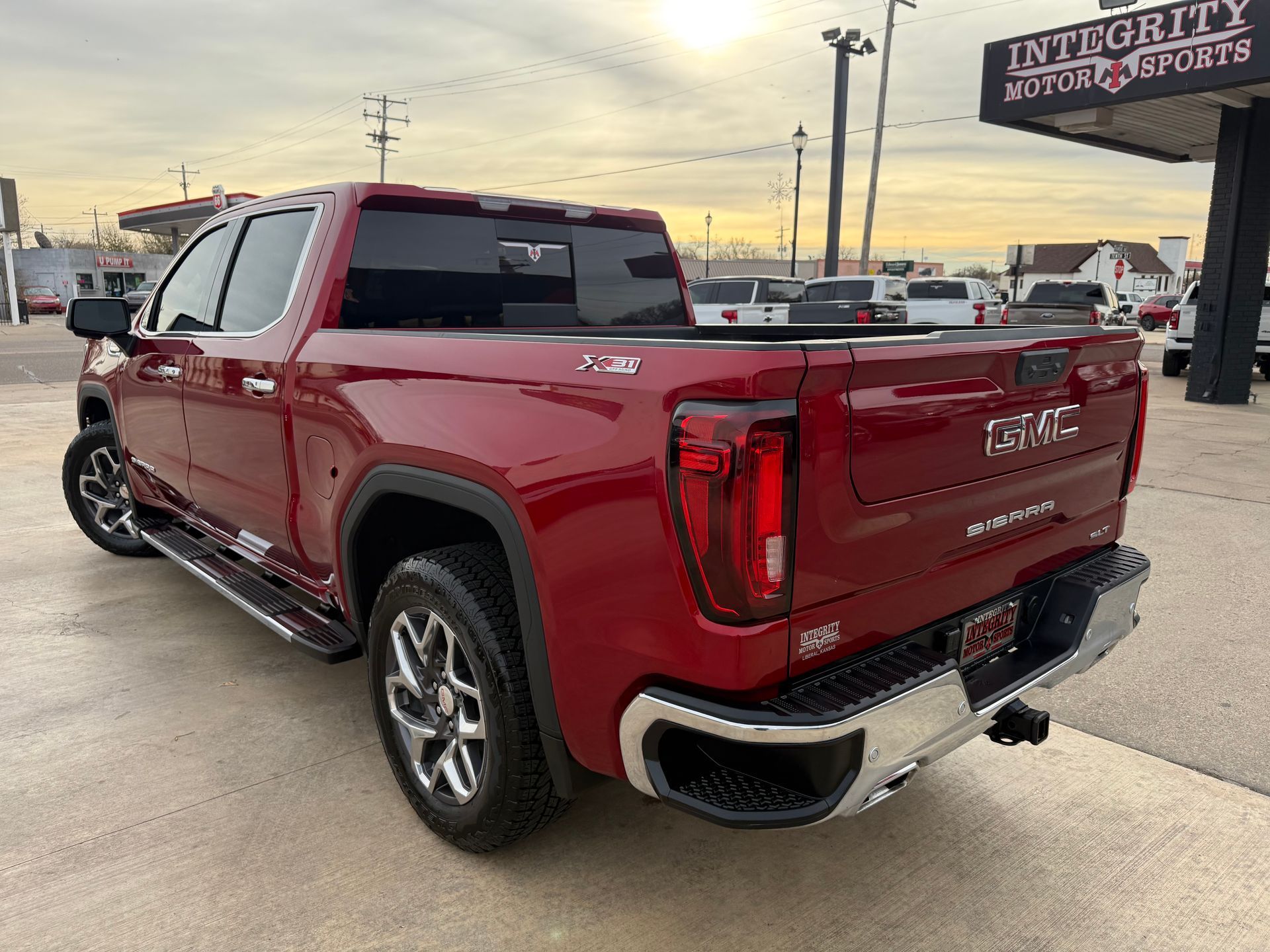 Red GMC Sierra truck parked at Integrity Motor Sports.