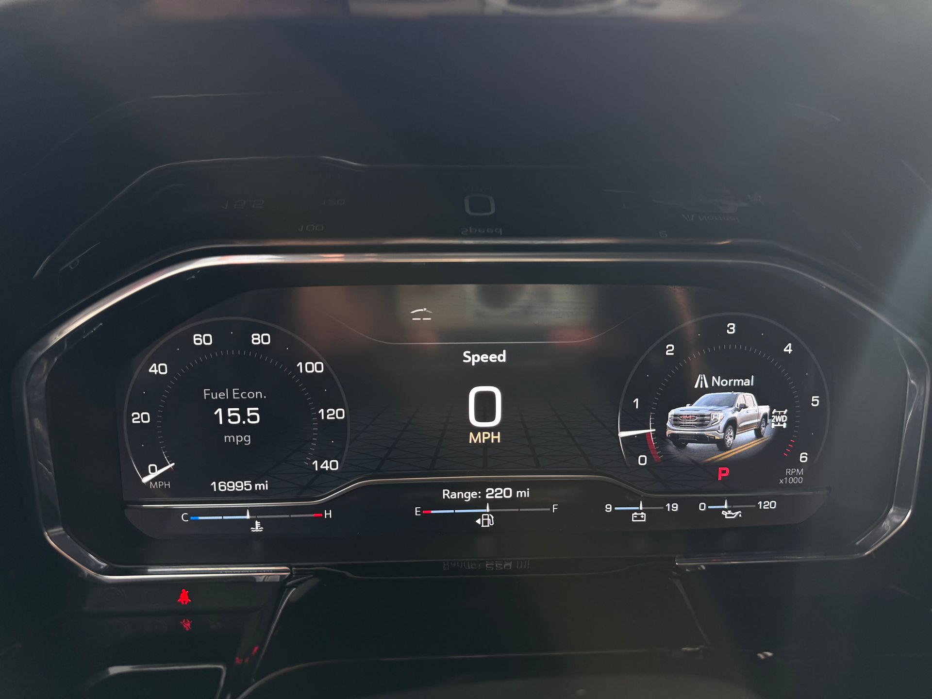 Dashboard displaying vehicle information: speedometer at 0 mph, fuel level, and vehicle image.