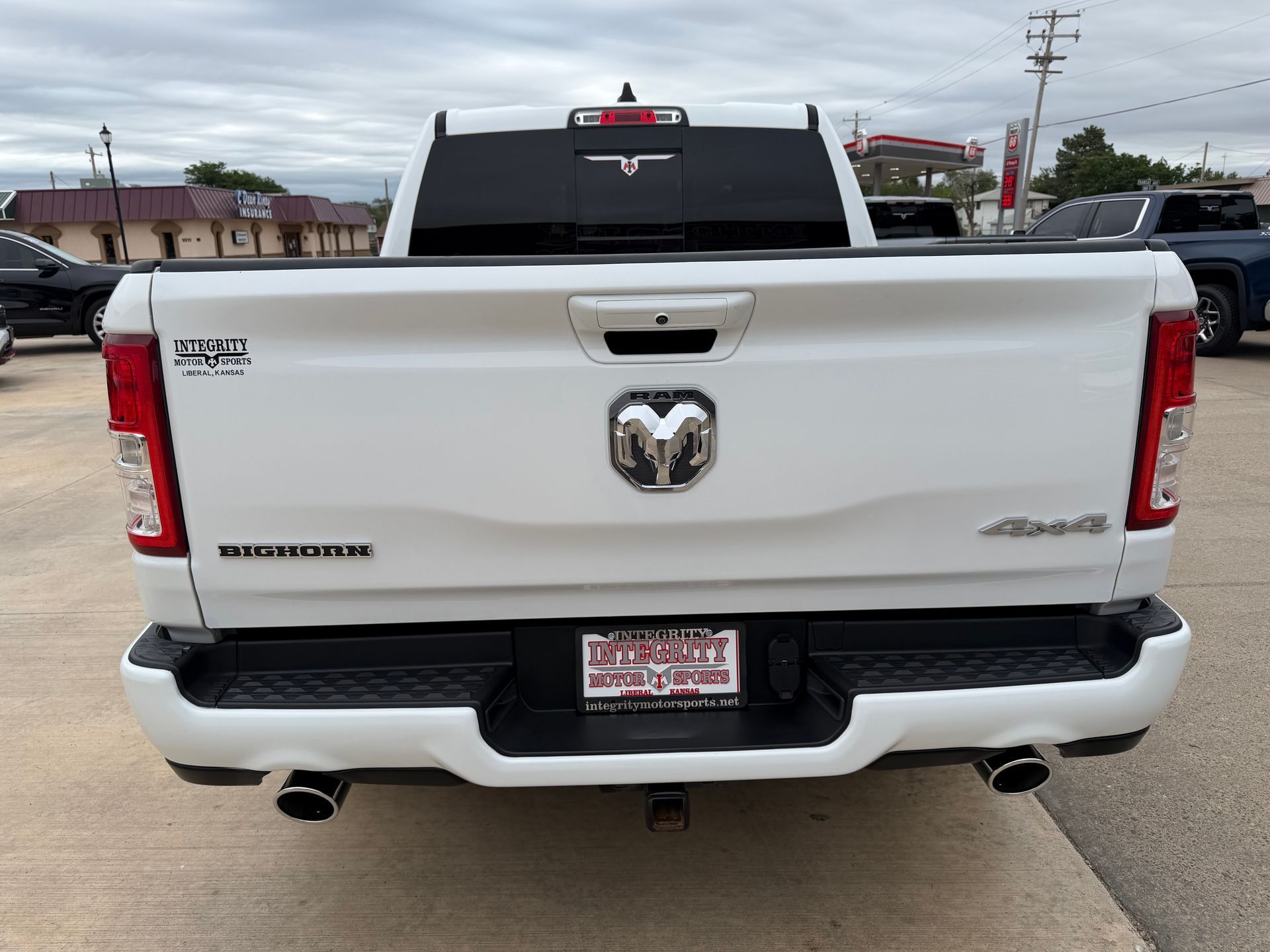 Rear view of a white Ram pickup truck parked on a street.