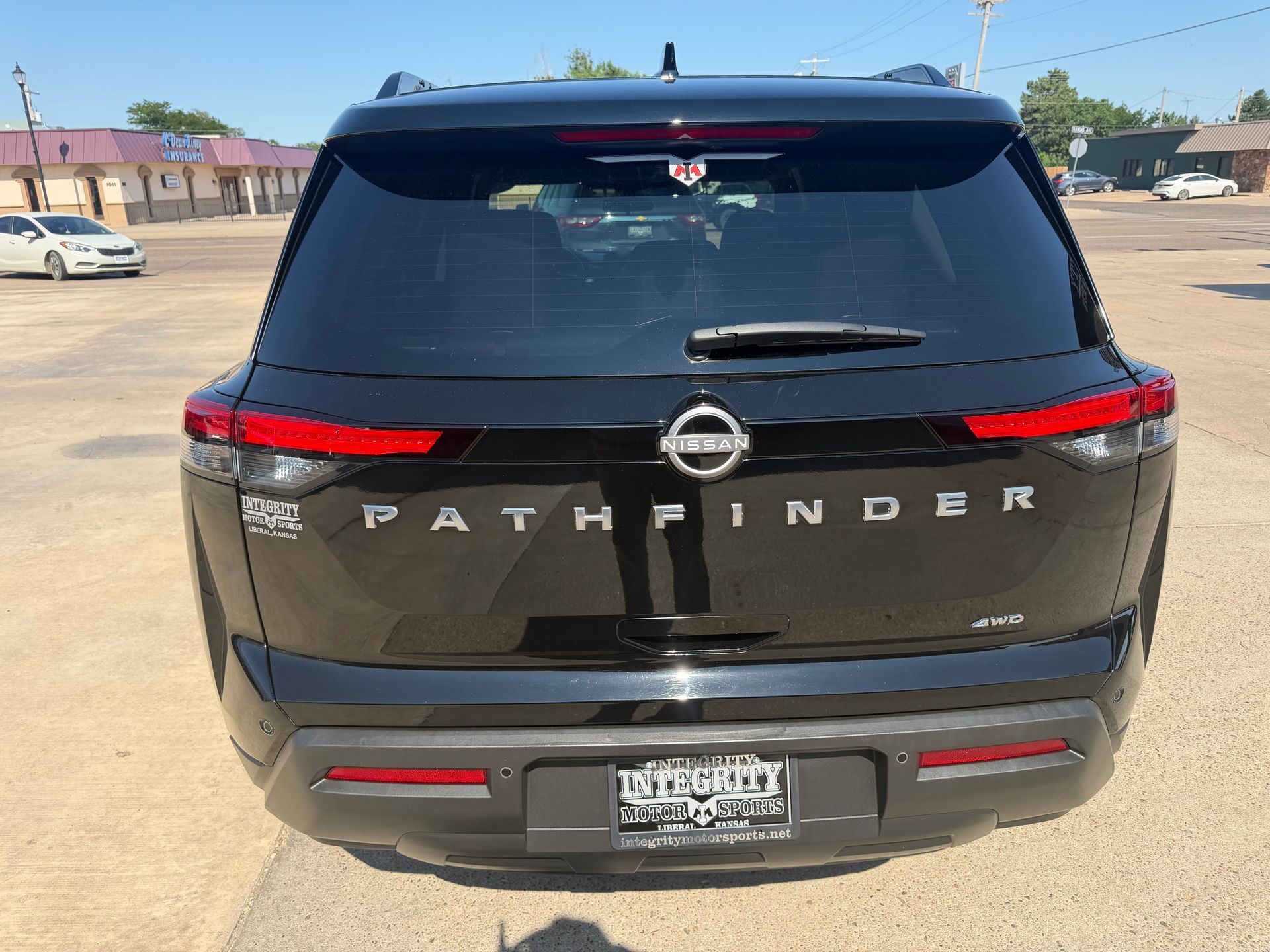 Rear view of a black Nissan Pathfinder SUV parked on a sunny lot