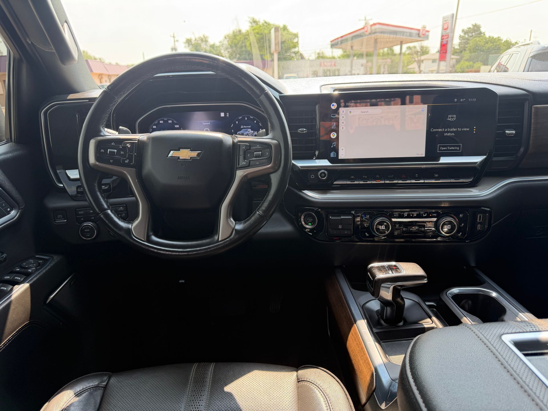 Chevrolet SUV dashboard and steering wheel, with touchscreen and center console visible from the driver’s seat