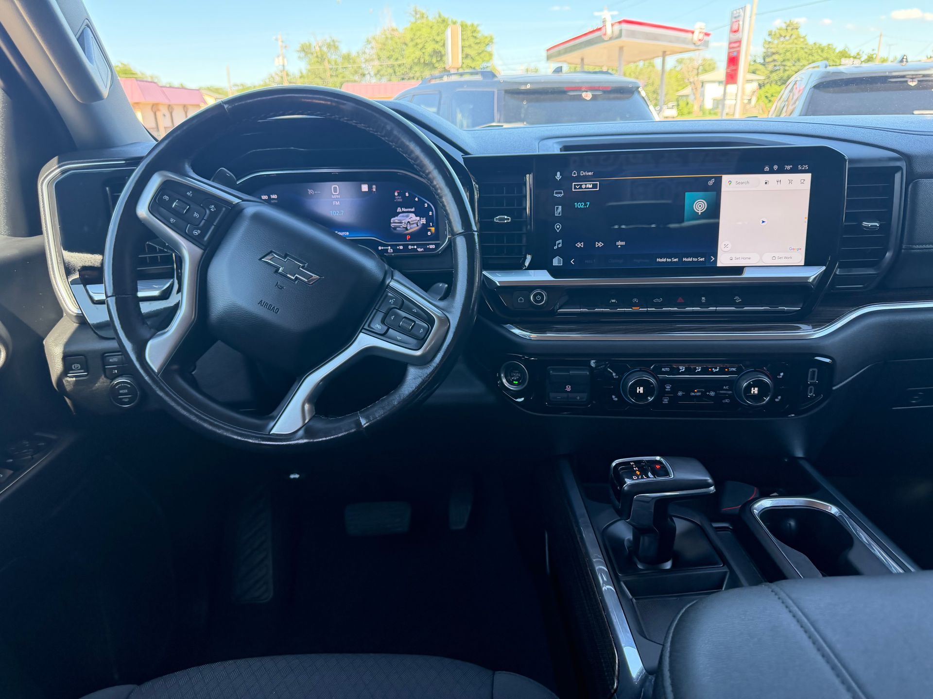 Interior of a modern Ford vehicle, showing the steering wheel, dashboard, and center touchscreen.