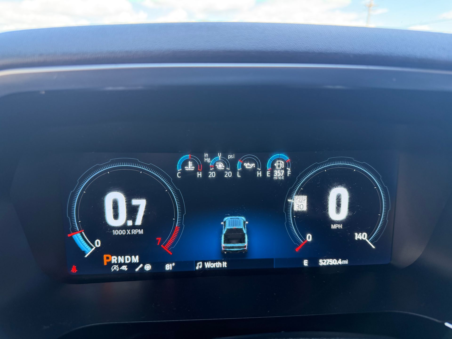 Car dashboard digital display showing 0.7 miles of range and 0 mph speed.