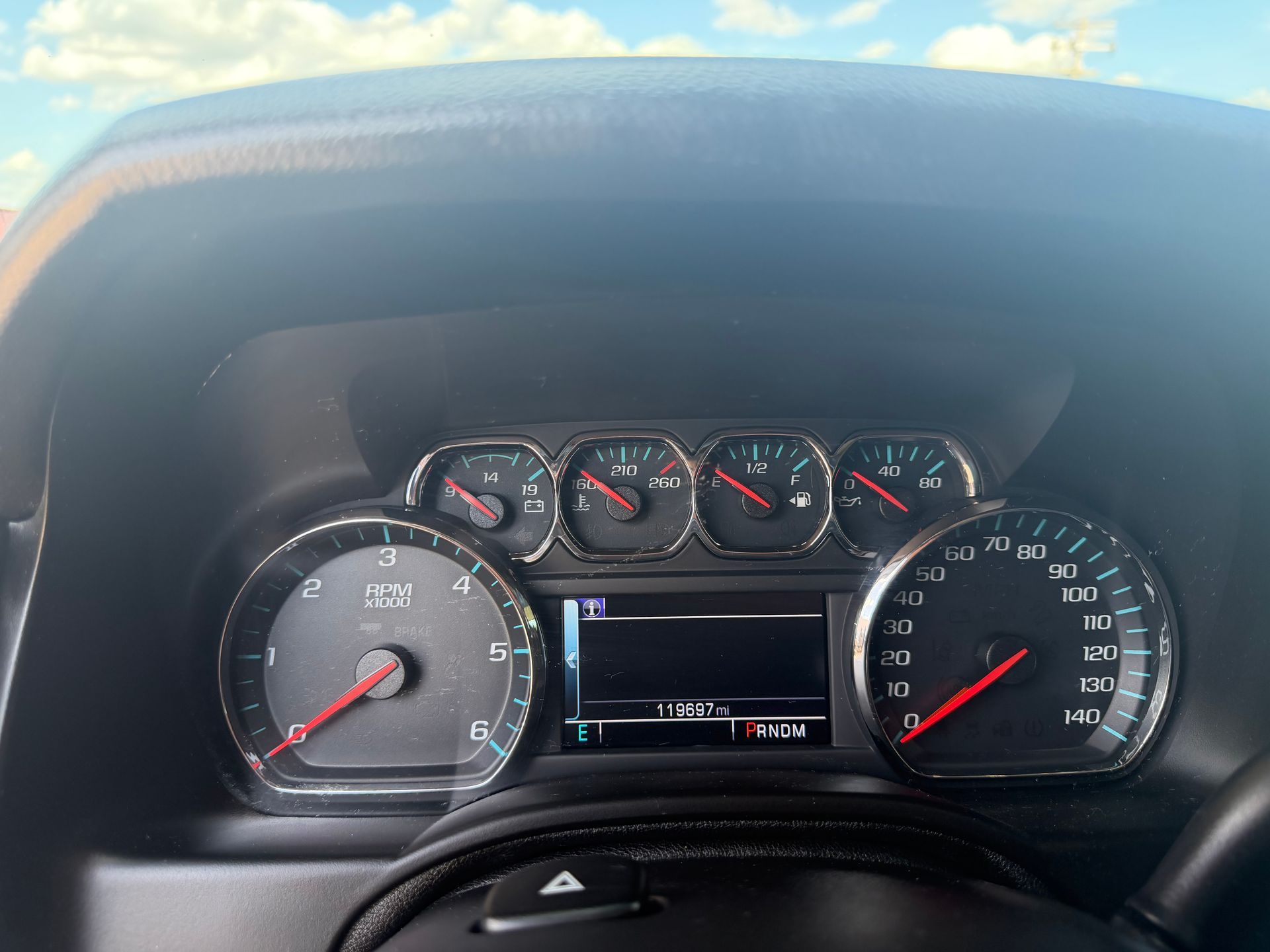 Car dashboard with analog gauges and a central digital display