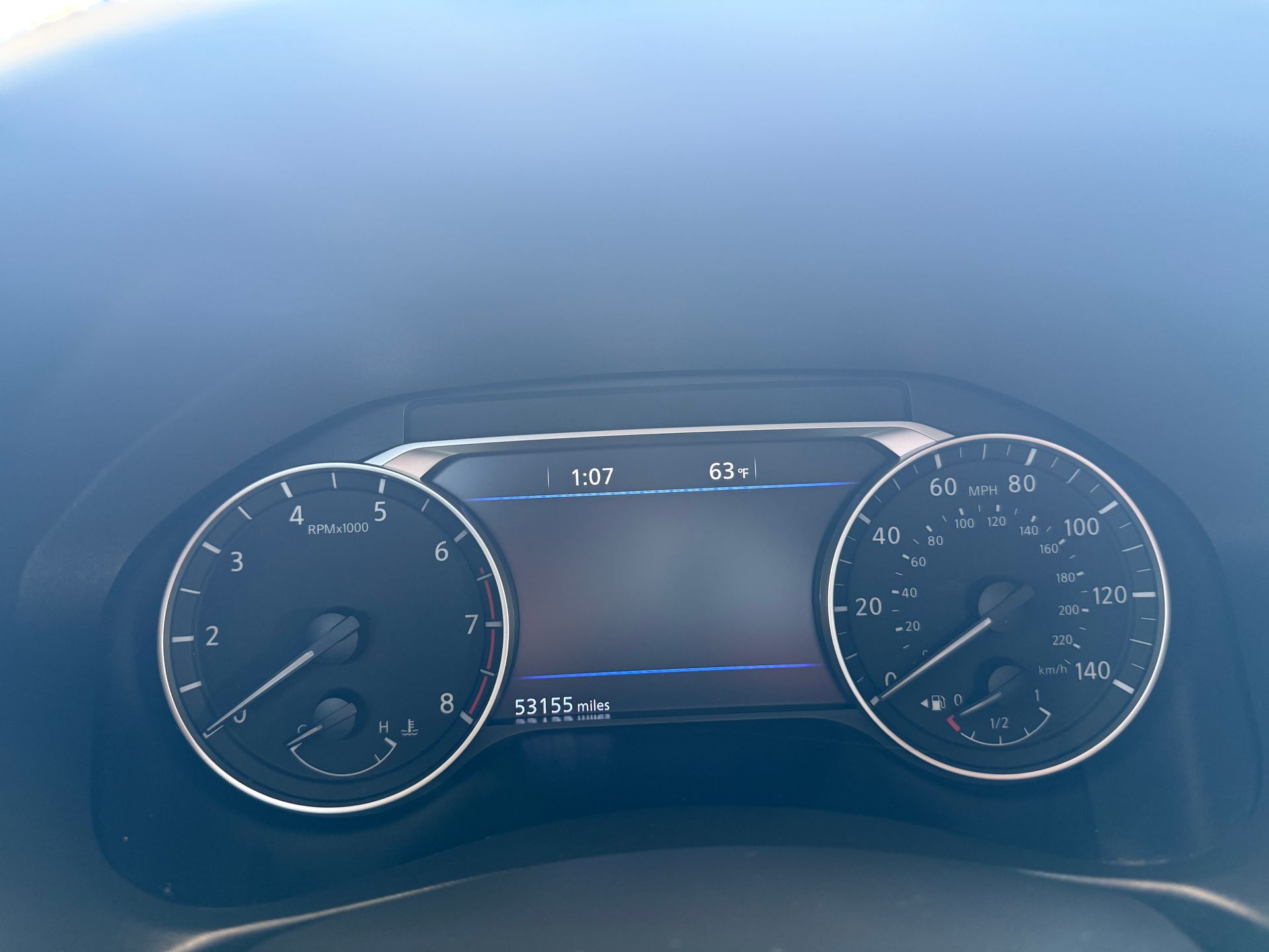 Car dashboard with speedometer at 63 mph, tachometer at 1, and odometer display.