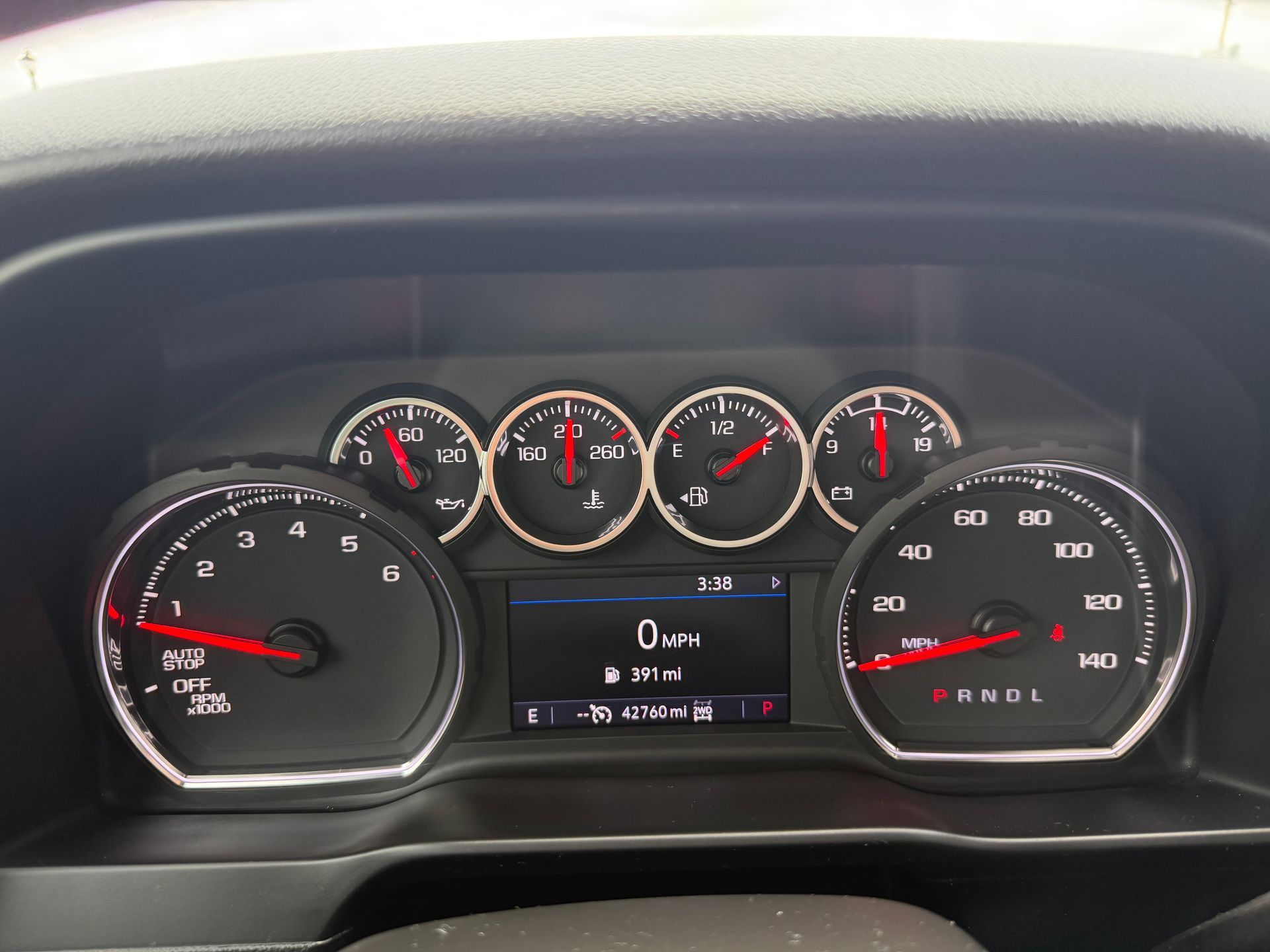 Dashboard of a vehicle. Gauges include speedometer and fuel.  Center display shows information.