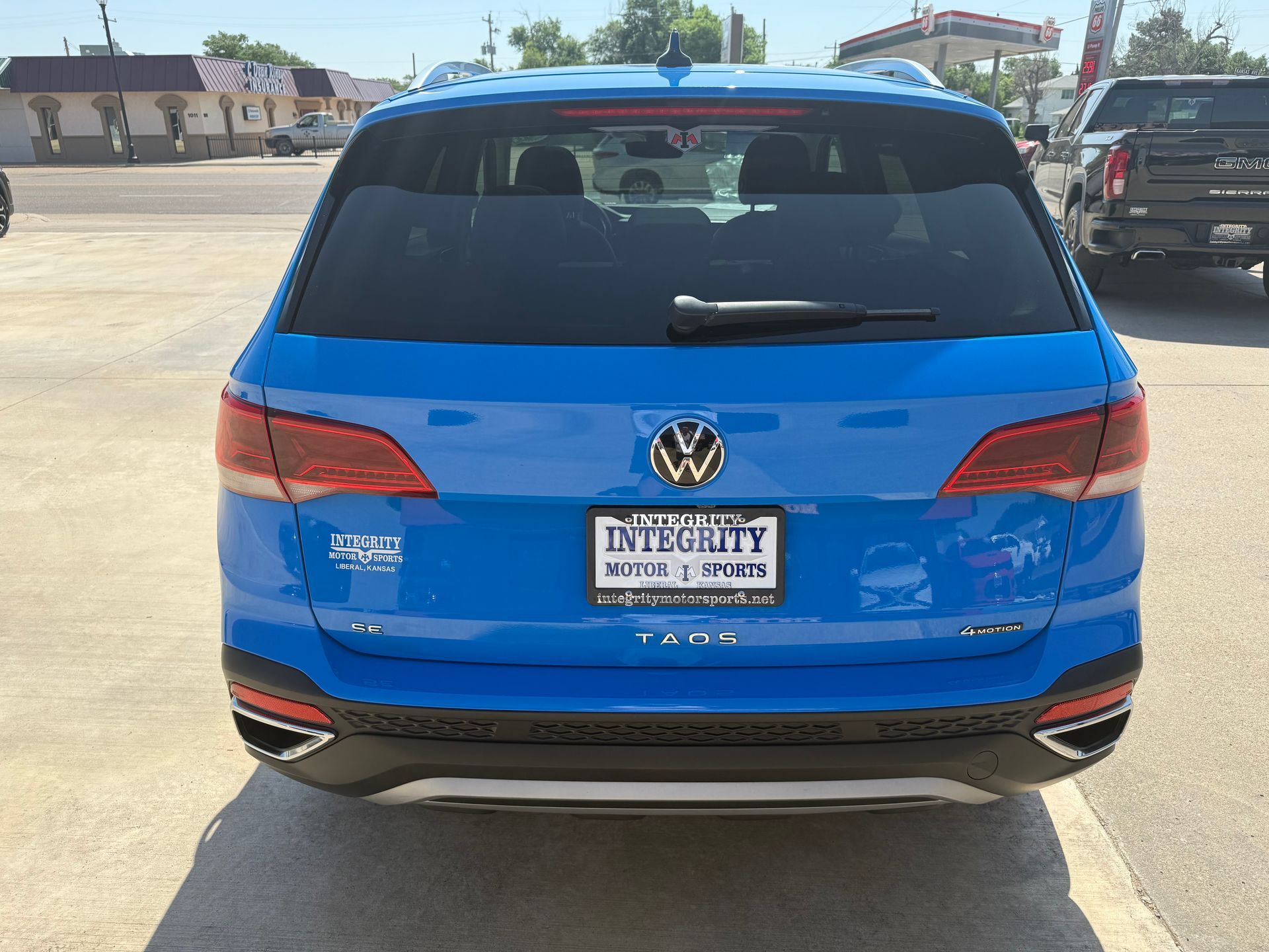 Blue Volkswagen Atlas SUV with a license plate, parked outside.