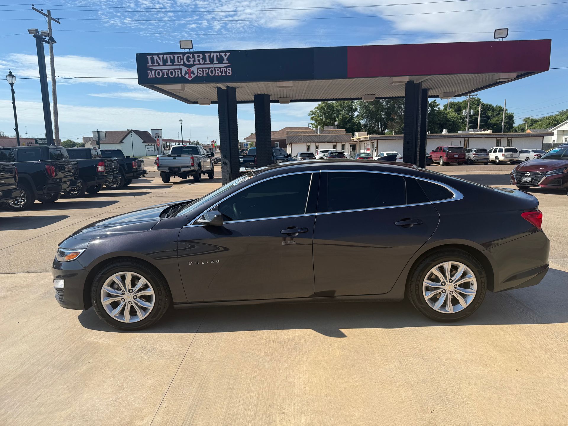 Gray sedan parked at Integrity Motor Sales.