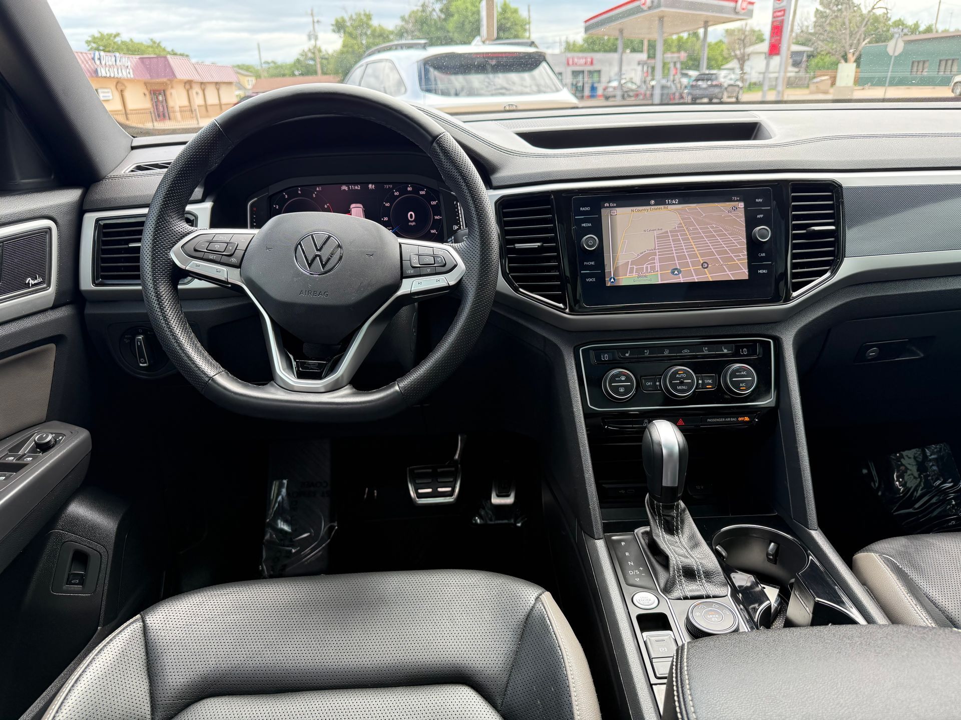 Interior of a Volkswagen Atlas SUV, featuring the steering wheel, dashboard, and infotainment screen.