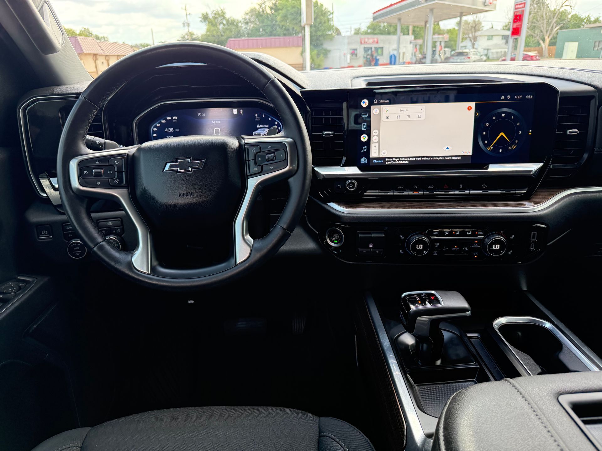 Interior view of a Chevrolet truck dashboard with a large touchscreen, steering wheel, and center console.
