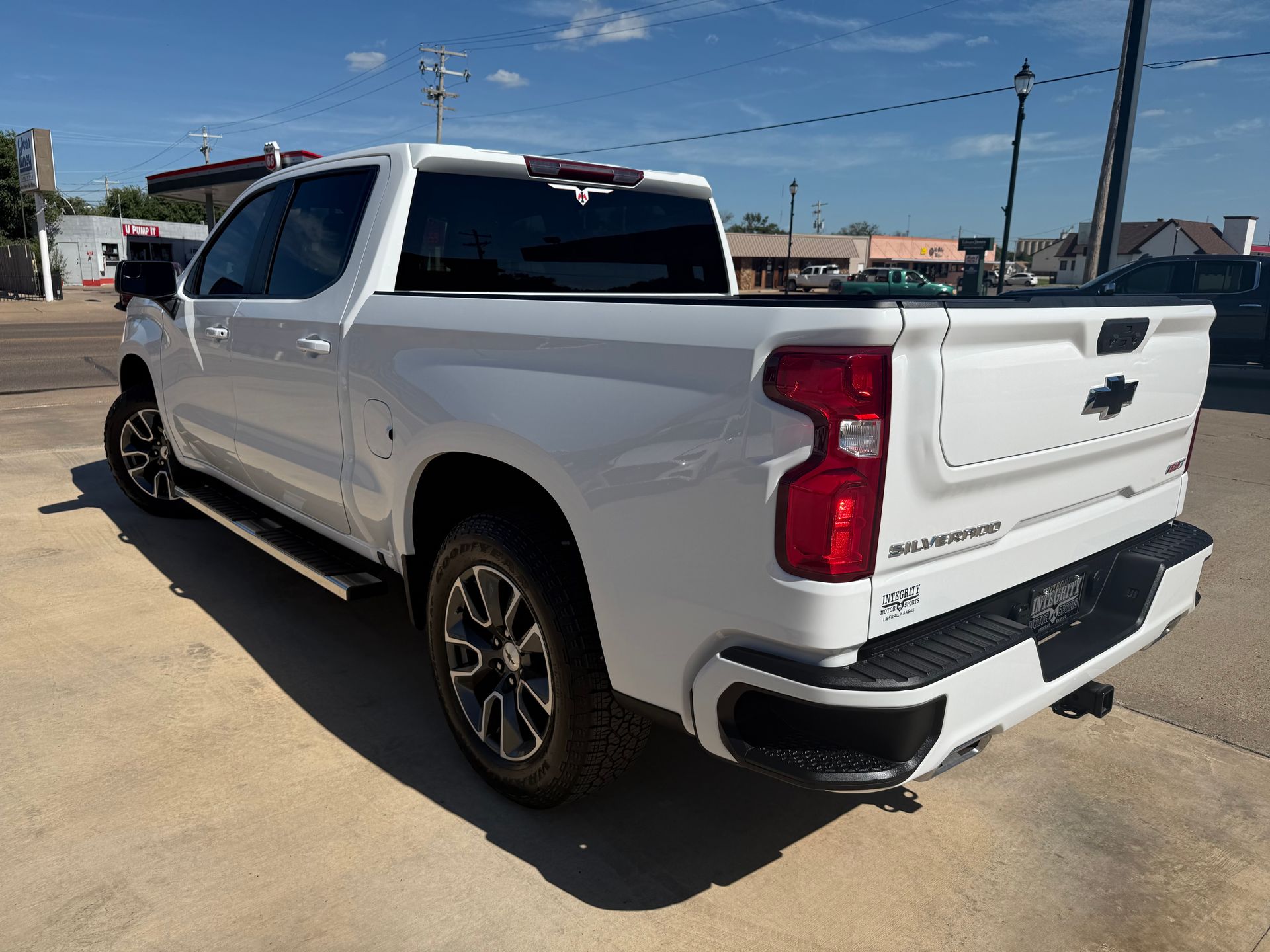 White Chevrolet Silverado pickup truck parked outdoors on a sunny day.