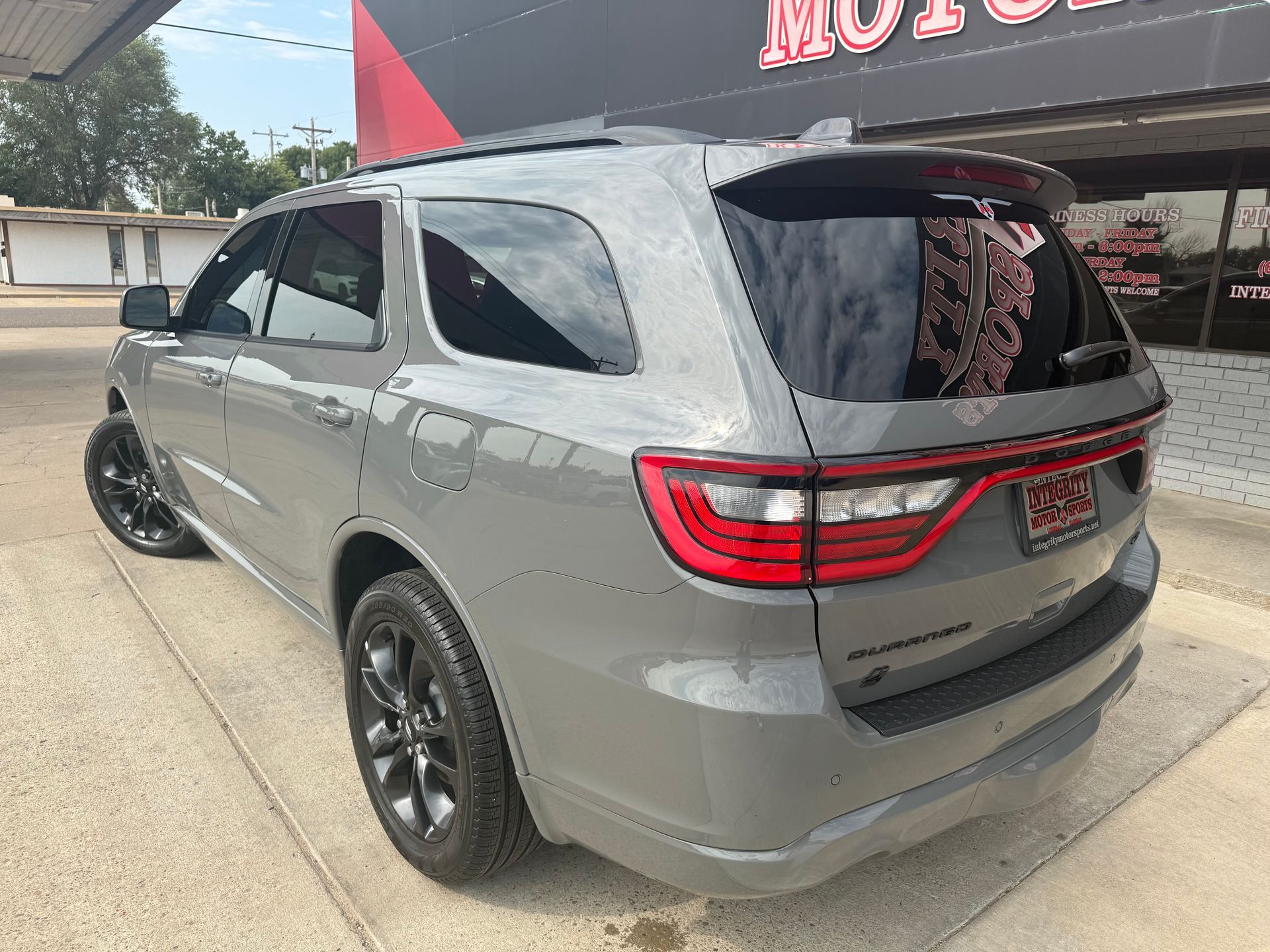 Gray Dodge Durango SUV parked outdoors, black wheels, tinted windows.