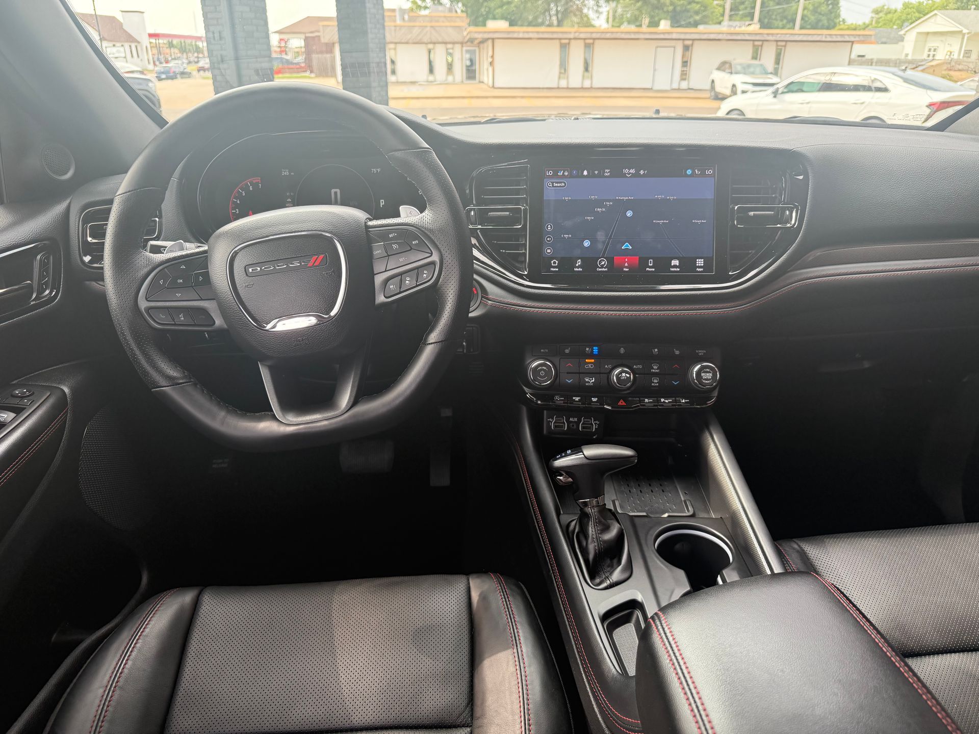 Dashboard view of a black Dodge Durango interior with touchscreen display, steering wheel, and center console.