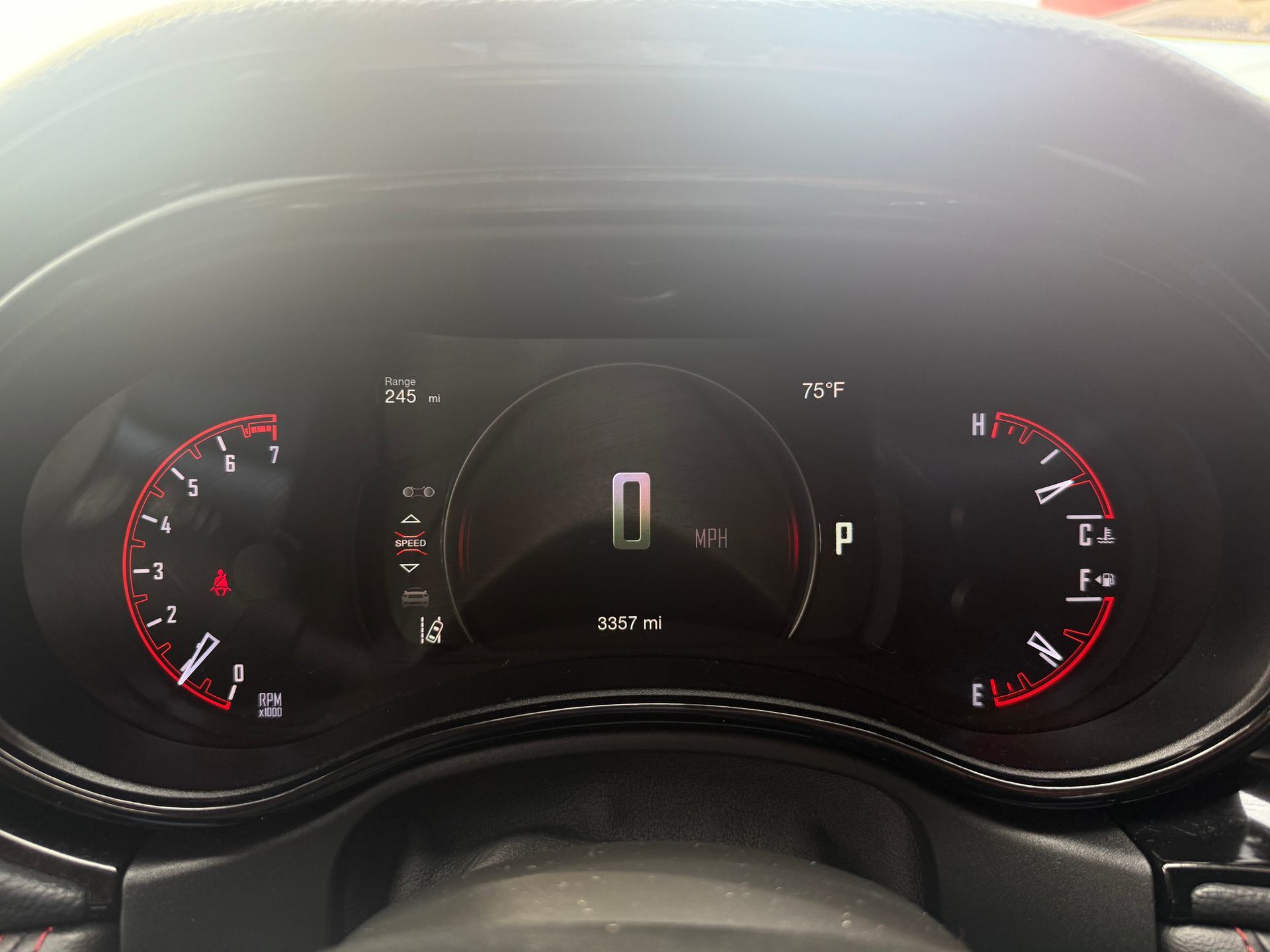 Dashboard displaying zero speed and vehicle information, with red gauges and a central digital display.
