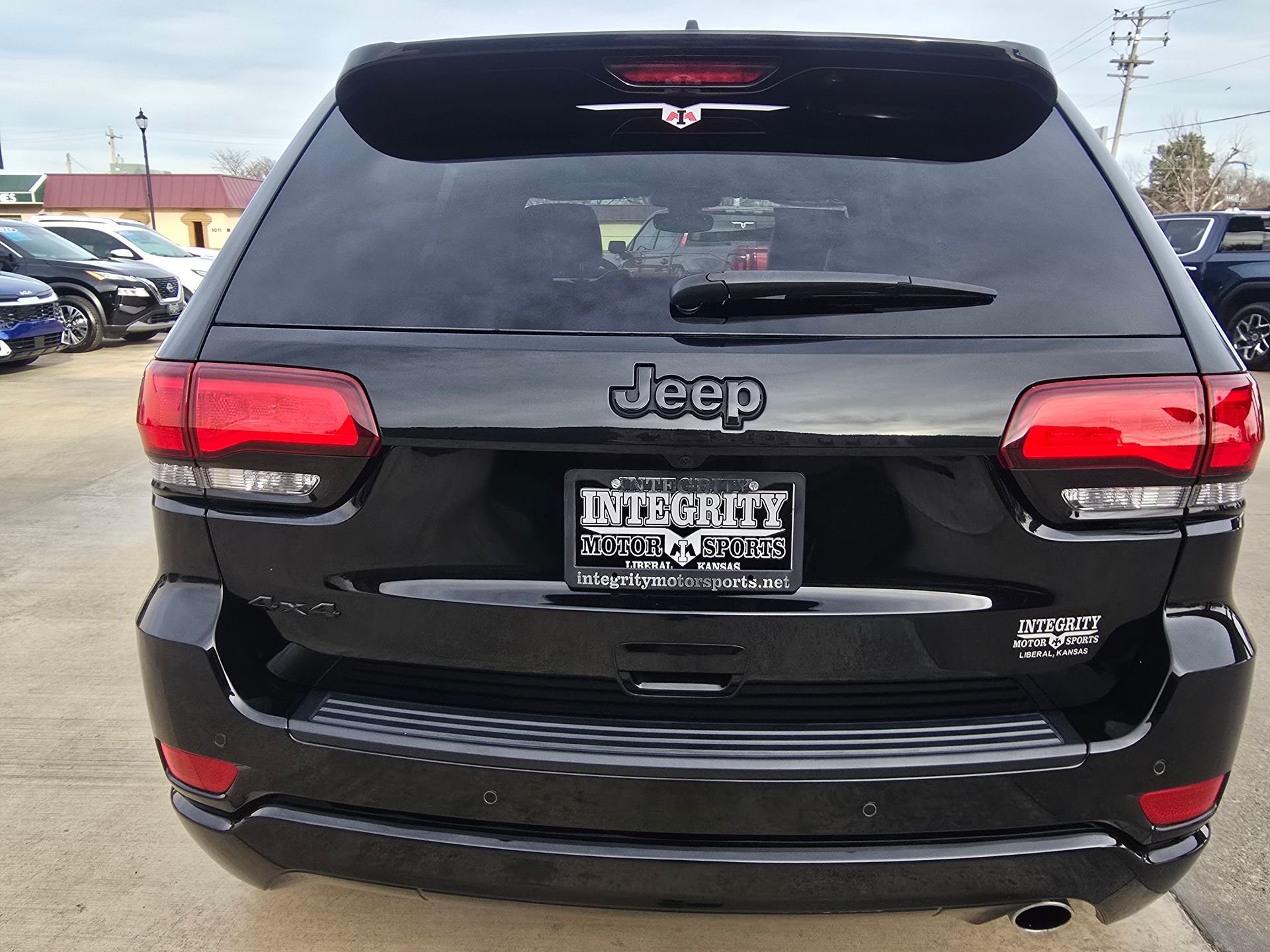Rear view of a black Jeep Grand Cherokee with a 