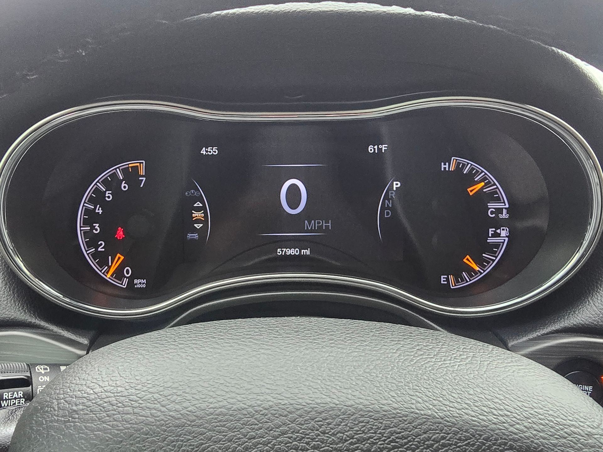 Dashboard of a Jeep Grand Cherokee showing gauges at zero and various warning lights illuminated.