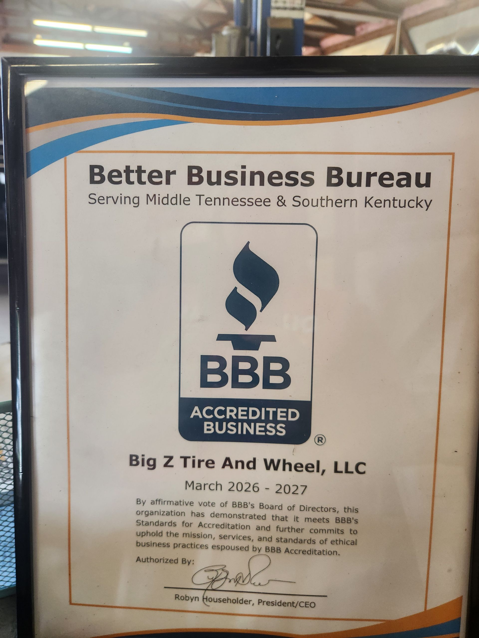 Better Business Bureau accredited business certificate for Big Z Tire And Wheel, LLC, in a framed display